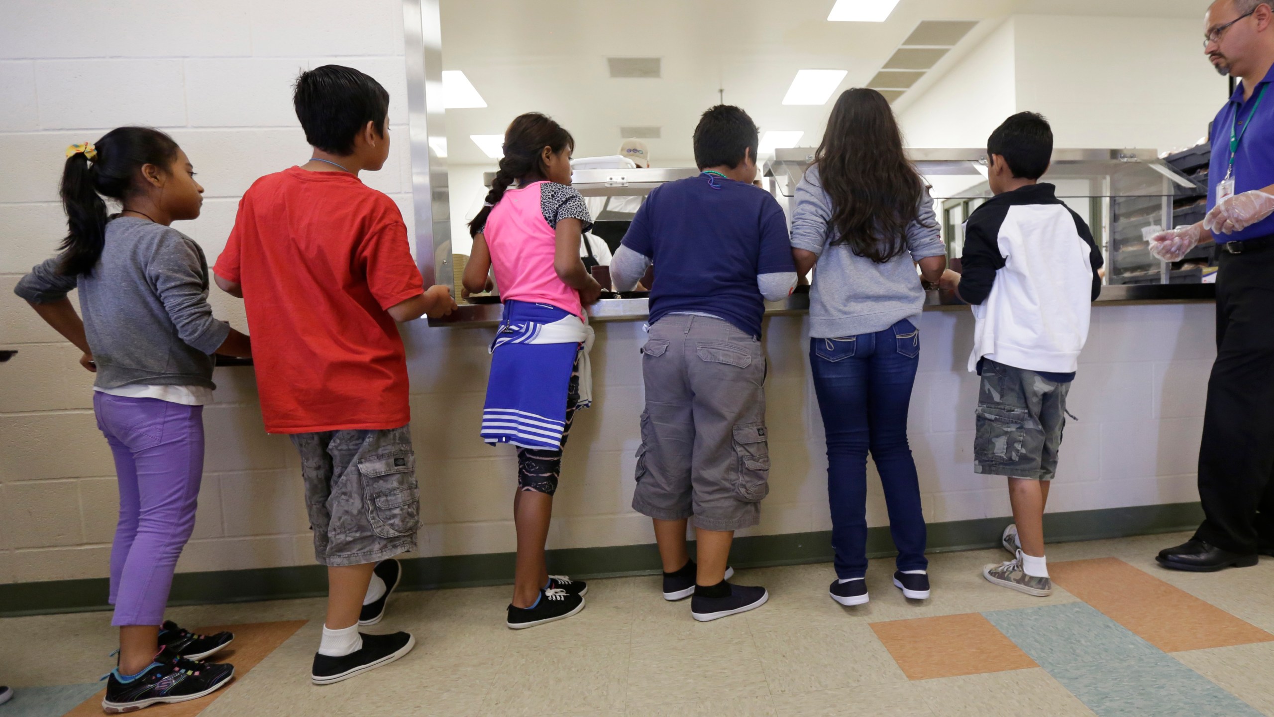 FILE - Detained immigrant children line up in the cafeteria at the Karnes County Residential Center, a detention center for immigrant families, in Karnes City, Texas on Sept. 10, 2014. (AP Photo/Eric Gay, File)