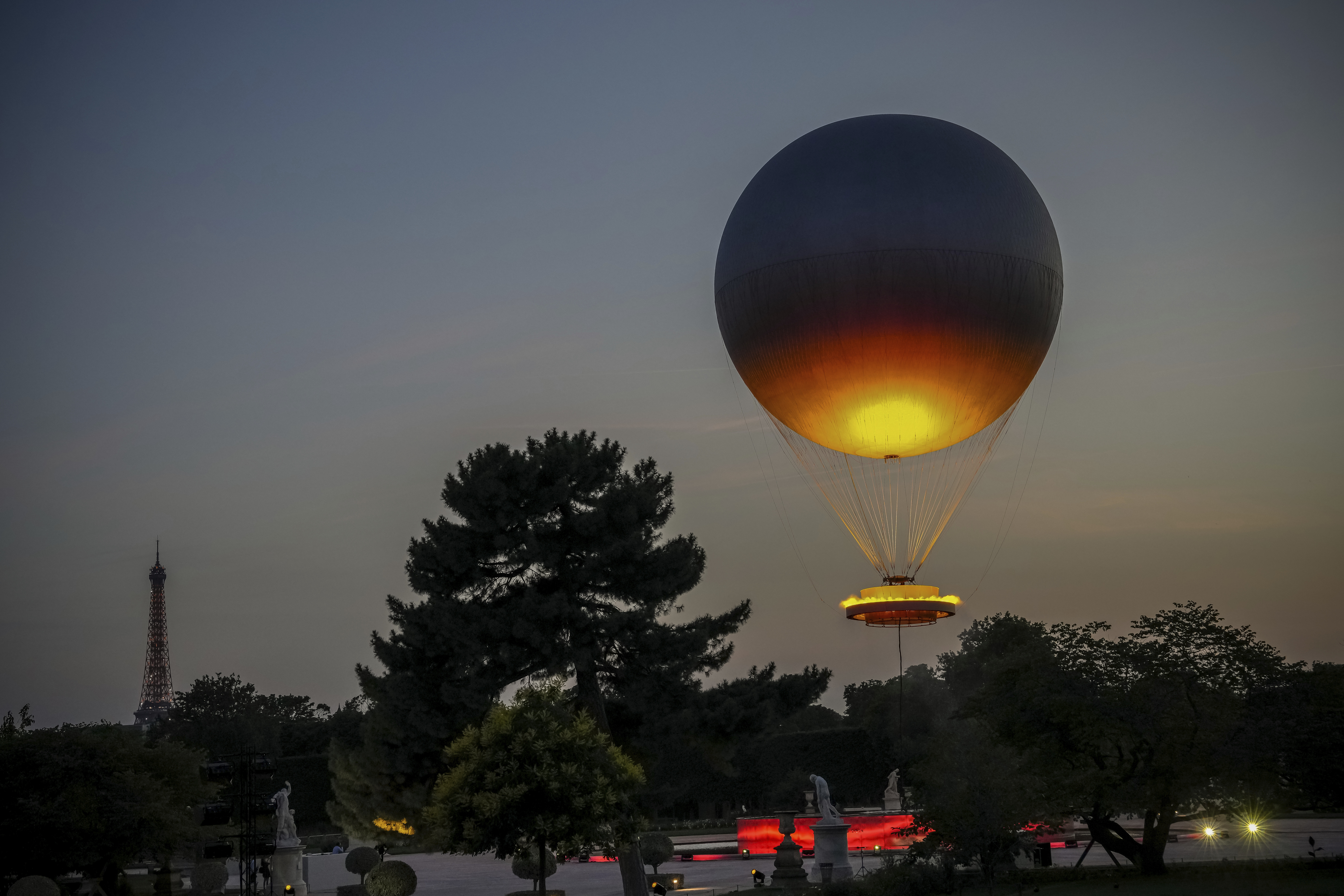 The helium ballon that was used during the 2024 Olympic Games as the Olympic cauldron is launched in the Tuileries Gardens of Paris on Saturday, June 21, 2025, with the Eiffel Tower in the background. (AP Photo/Aurelien Morissard)