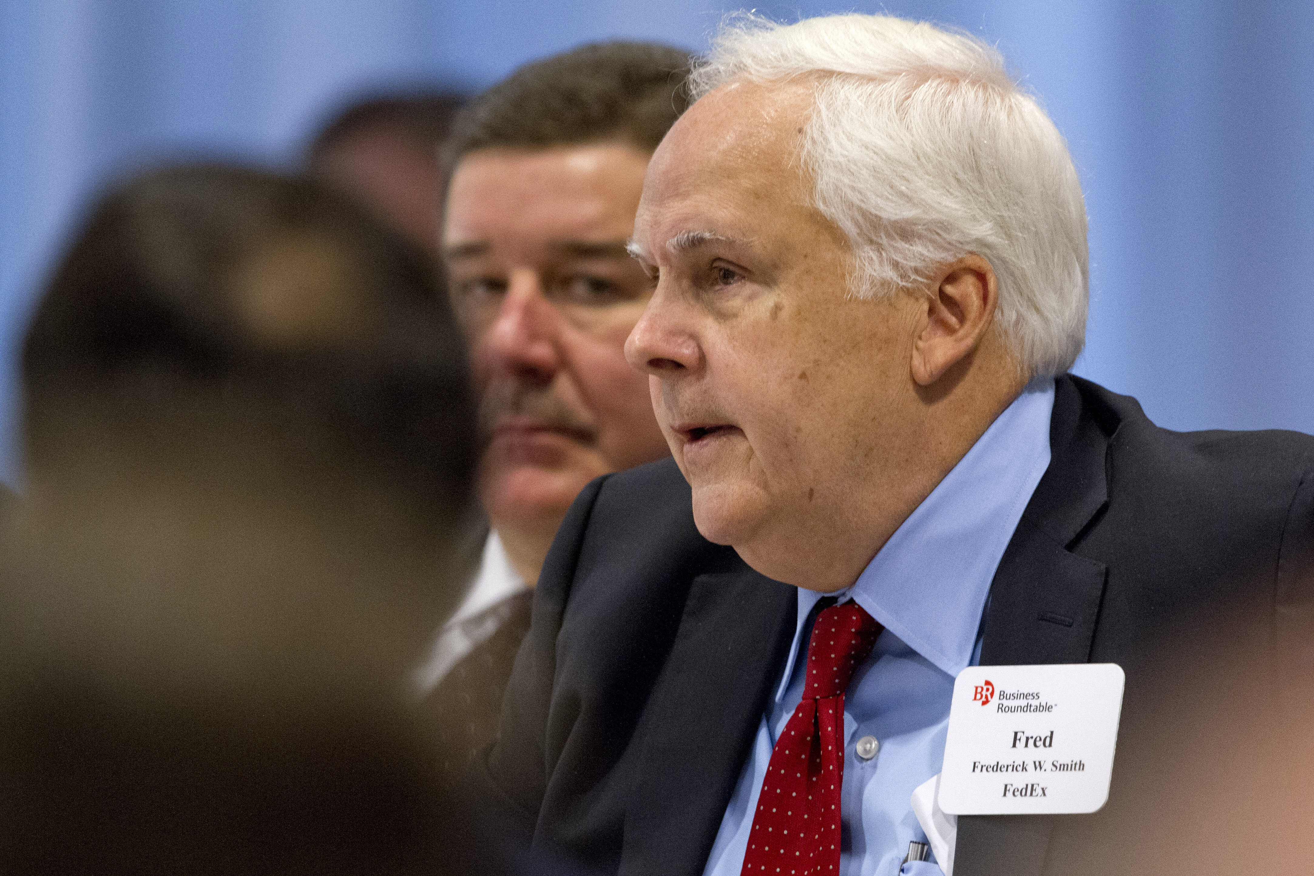 FILE - FedEx founder and CEO Fred Smith asks a question of President Barack Obama during the president's meeting with leading CEOs to discuss ways to promote the economy and create jobs during his last two years in office, Wednesday, Dec. 3, 2014, at the Business Roundtable Headquarters in Washington. (AP Photo/Jacquelyn Martin, File)