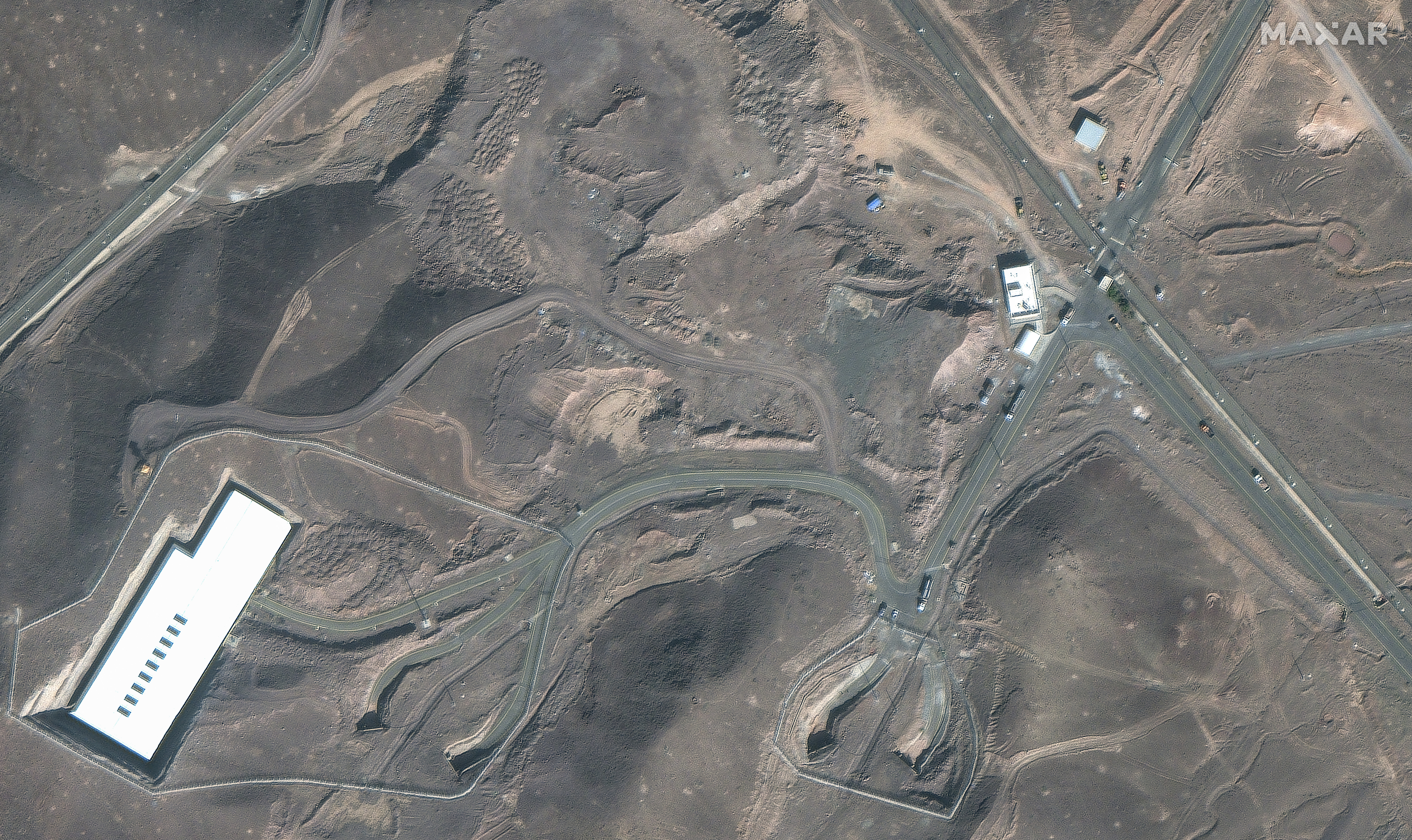 This satellite image provided by Maxar Technologies shows vehicles at the Fordo enrichment facility in Iran on Friday, June 20, 2025. (Maxar Technologies via AP)
