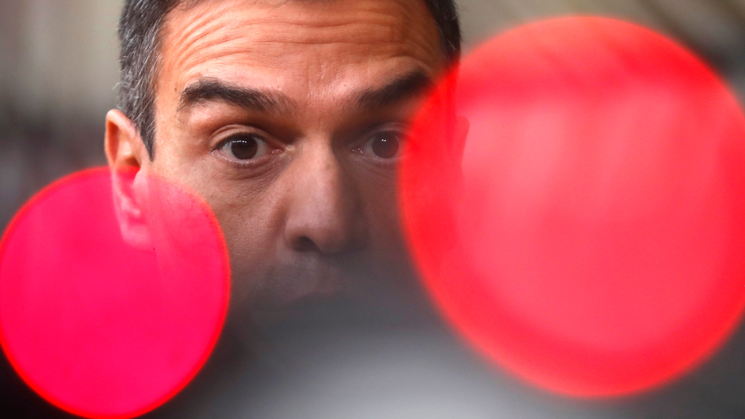 FILE- Spain's Prime Minister Pedro Sanchez speaks on camera as he arrives for an EU summit at the European Council building in Brussels, Oct. 1, 2020. (AP Photo/Francisco Seco, File)