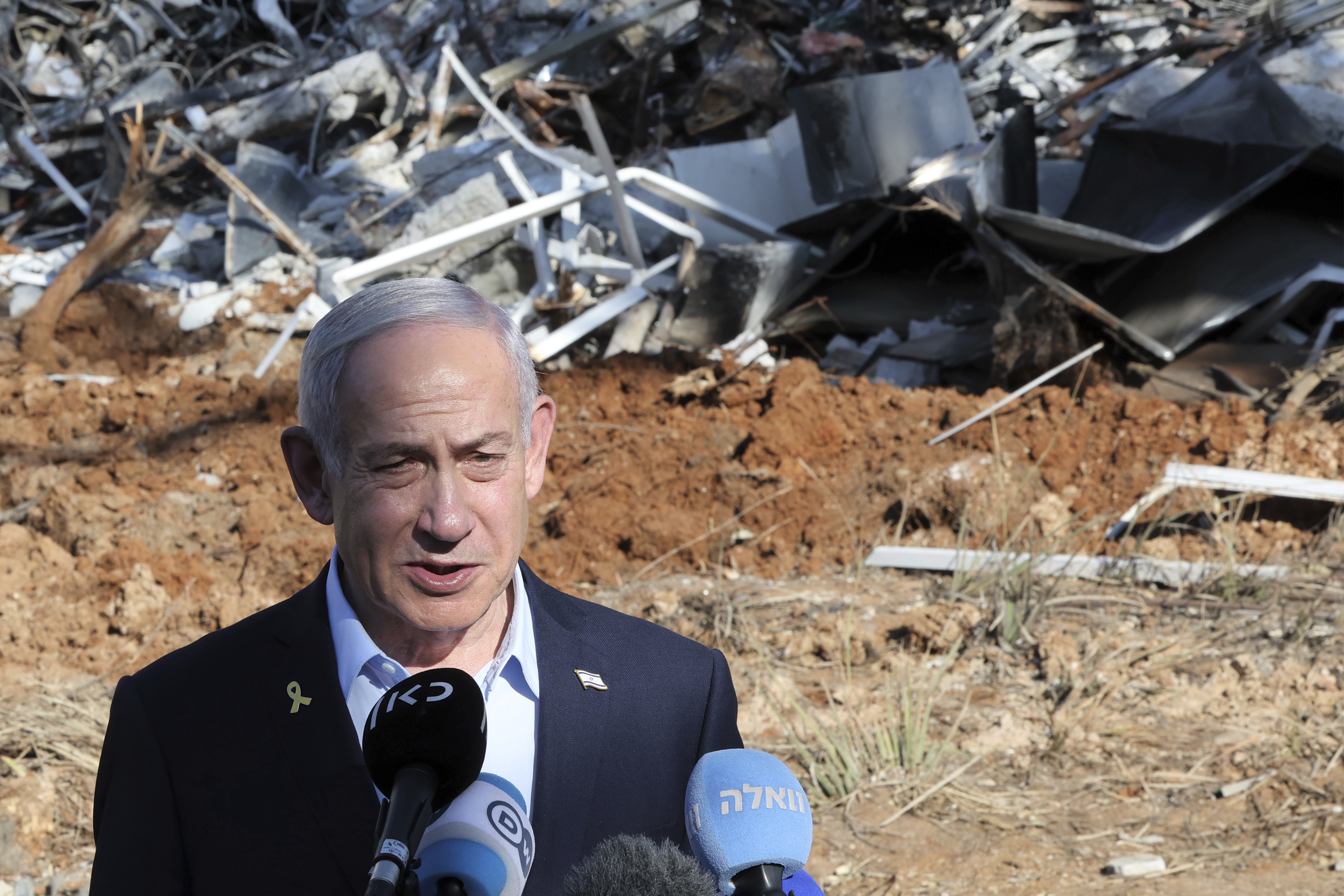 Israel's Prime Minister Benjamin Netanyahu gives a statement during a visit to the site of the Weizmann Institute of Science, which was hit by missiles fired from Iran, in the central city of Rehovot on Friday, June 20, 2025. (Jack Guez/Pool Photo via AP)