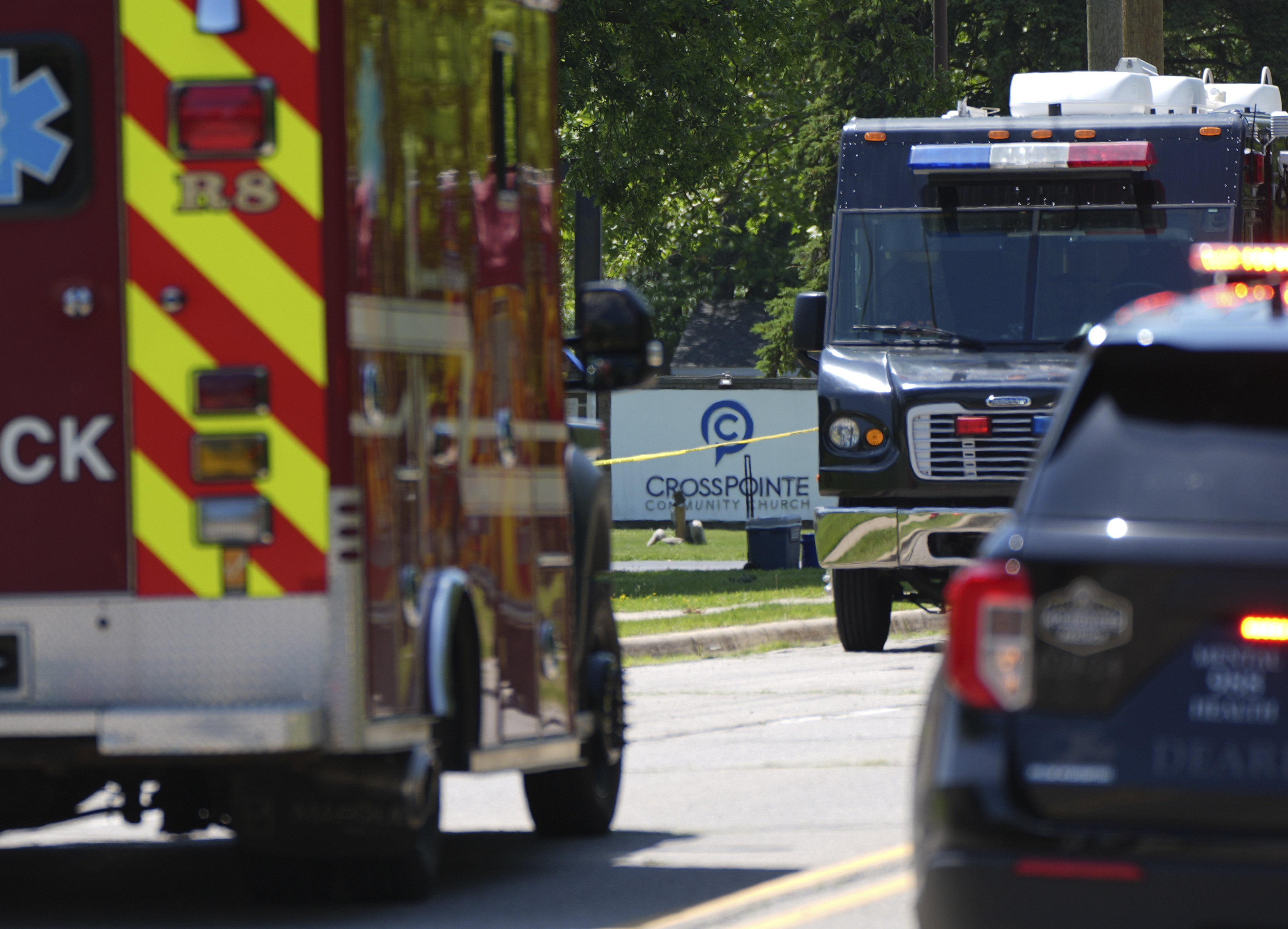 Emergency vehicles gather near CrossPointe Community Church in Wayne, Mich., Sunday, June 23, 2025. (AP Photo/Paul Sancya)