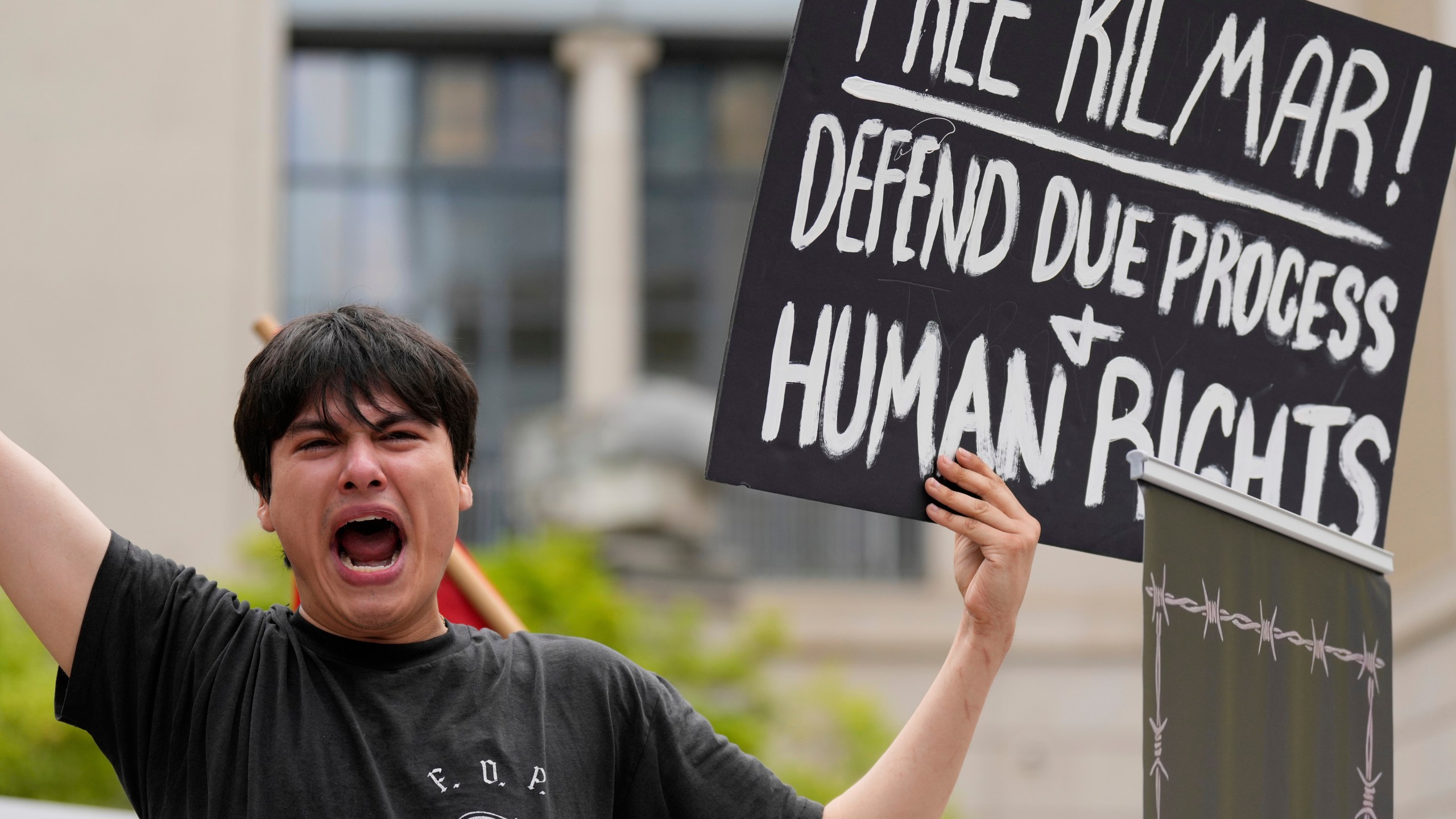 Tiki Osiris holds a sign as protesters gather outside the Federal Courthouse before arguments whether Kilmar Abrego Garcia can be released from jail on Friday, June 13, 2025 in Nashville, Tenn. (AP Photo/George Walker IV)