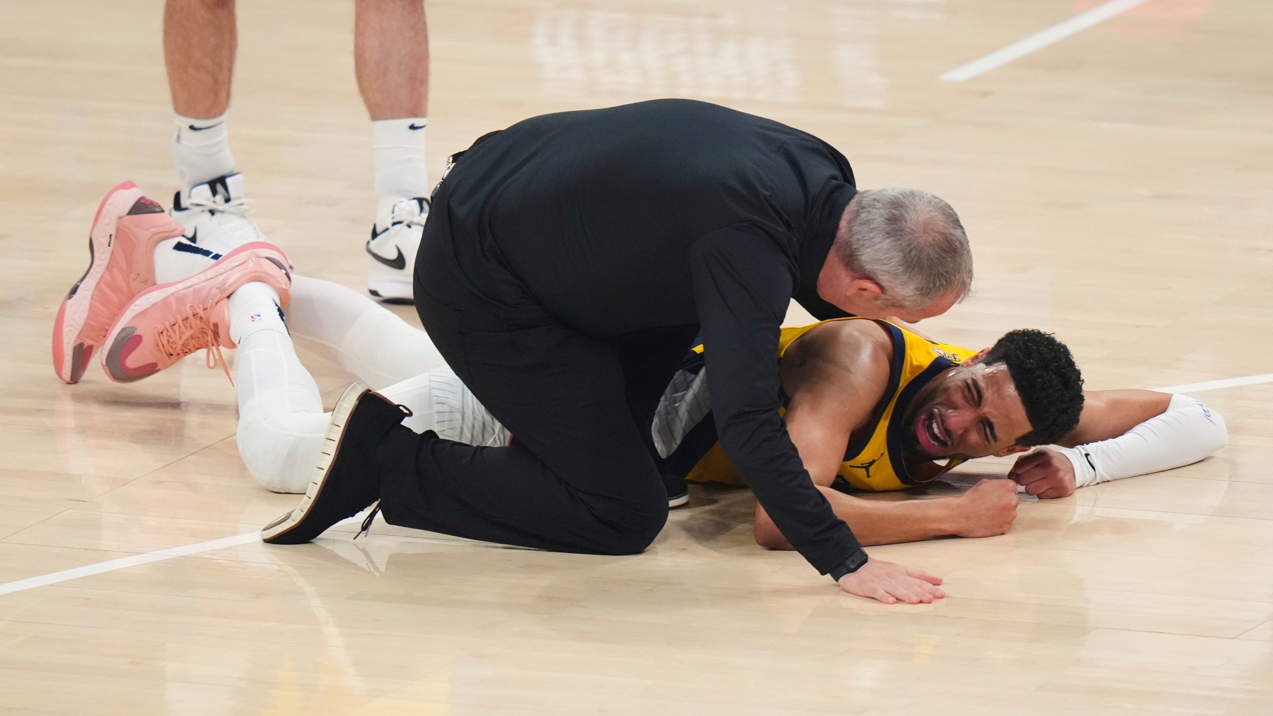 Indiana Pacers guard Tyrese Haliburton lays on the court after an injury during the first half of Game 7 of the NBA Finals basketball series against the Oklahoma City Thunder Sunday, June 22, 2025, in Oklahoma City. (AP Photo/Nate Billings)