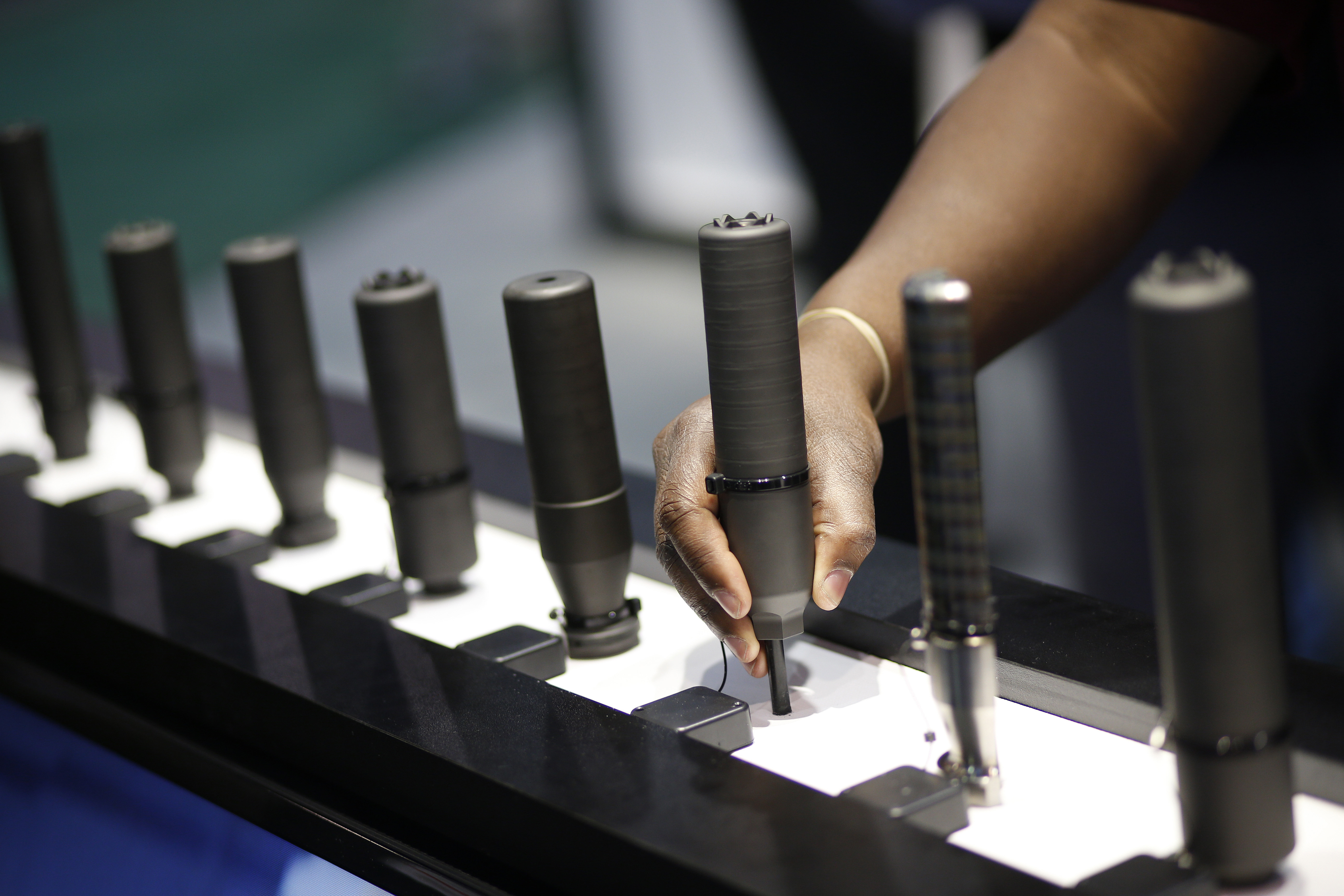 FILE- Gun silencers are on display at the Sig Sauer booth at the Shooting, Hunting and Outdoor Trade Show in Las Vegas, Jan. 19, 2016. (AP Photo/John Locher, File)