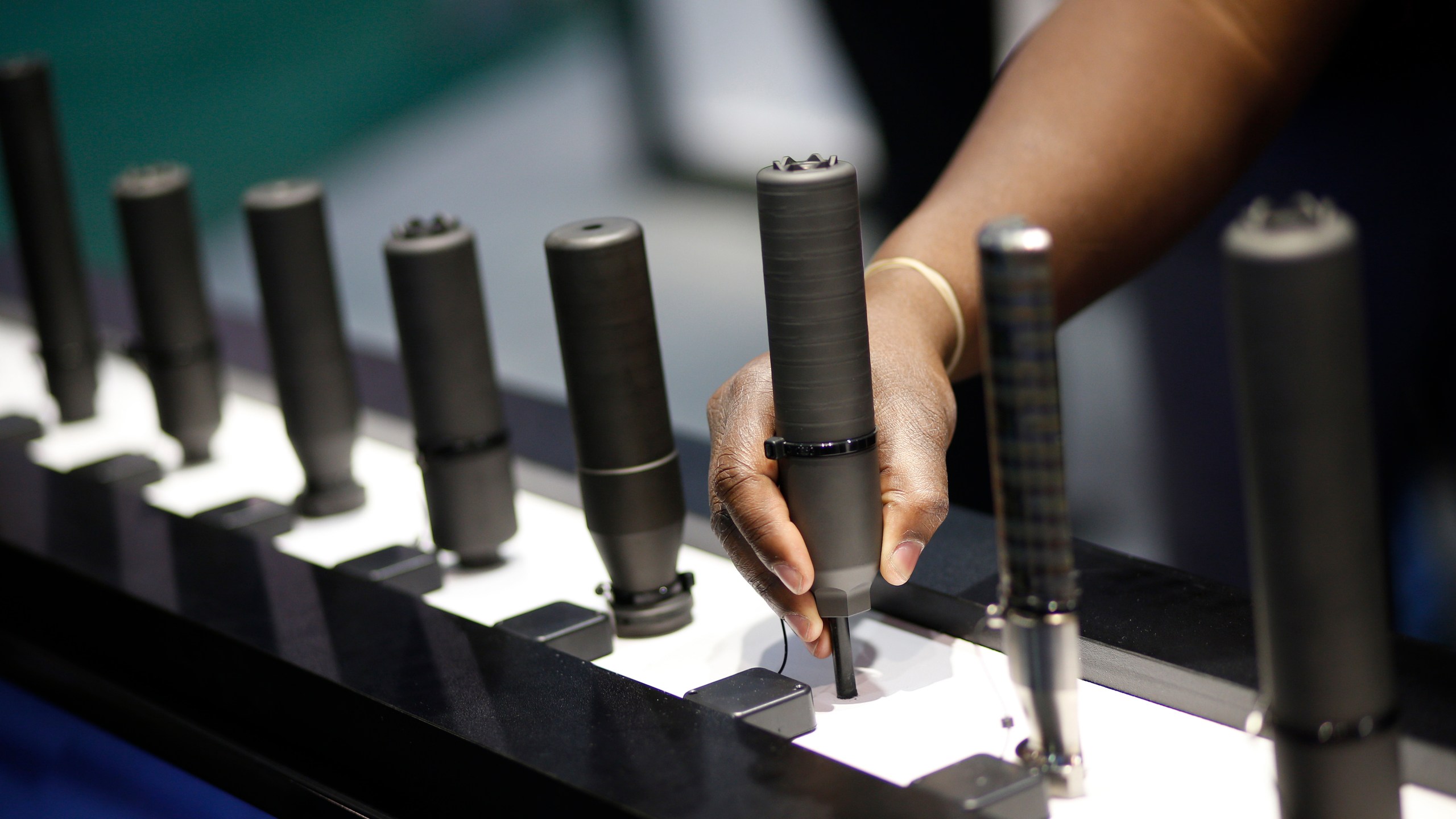 FILE- Gun silencers are on display at the Sig Sauer booth at the Shooting, Hunting and Outdoor Trade Show in Las Vegas, Jan. 19, 2016. (AP Photo/John Locher, File)