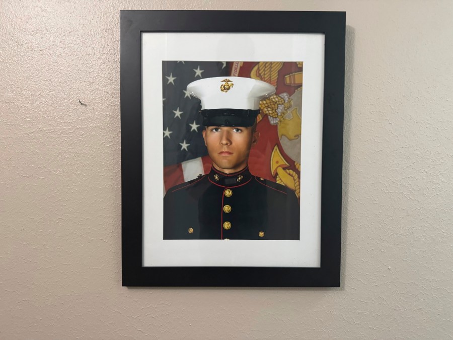 A portrait of Adrian Clouatre during his years of service with the U.S. Marine Corps hangs on the wall of his family's home in Baton Rouge on Tuesday, June 17, 2025. (AP Photo/Jack Brook)