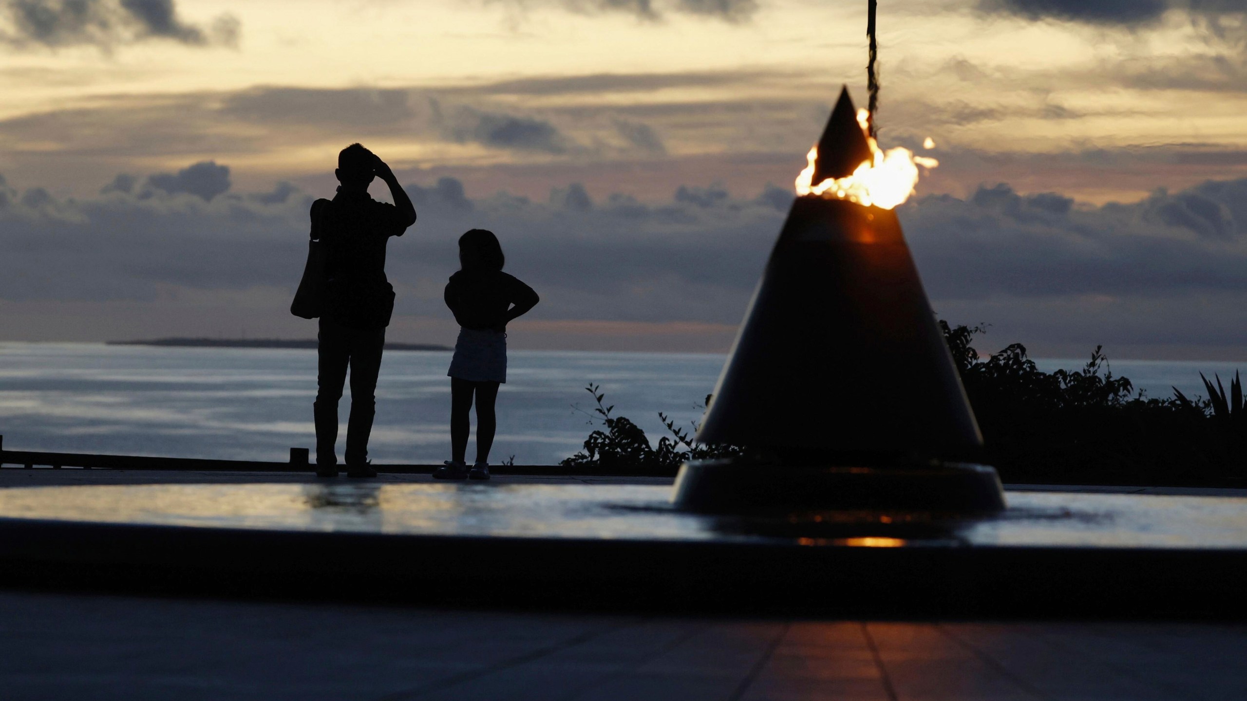 Visitors look towards the sea at the Peace Memorial Park in Itoman, Okinawa prefecture, southern Japan Monday, June 23, 2025 as Japan marked the 80th anniversary of the end of the Battle of Okinawa. (Haruna Furuhashi/Kyodo News via AP)
