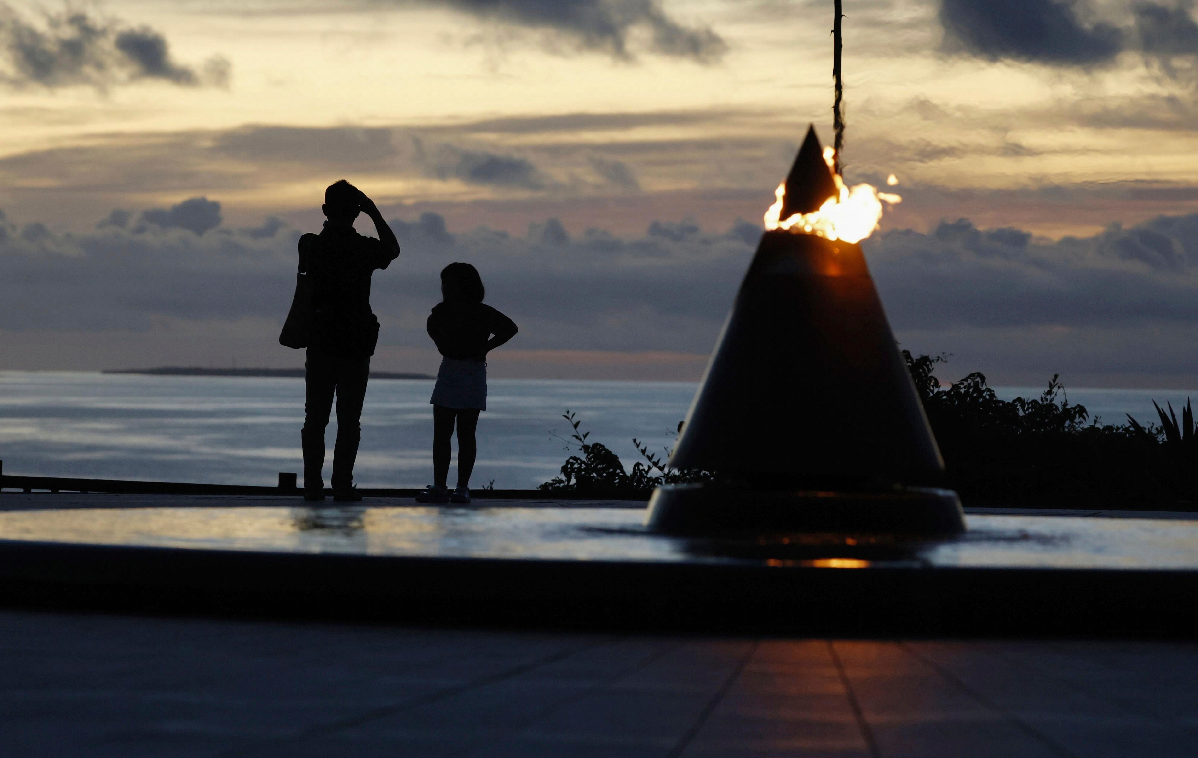 Visitors look towards the sea at the Peace Memorial Park in Itoman, Okinawa prefecture, southern Japan Monday, June 23, 2025 as Japan marked the 80th anniversary of the end of the Battle of Okinawa. (Haruna Furuhashi/Kyodo News via AP)