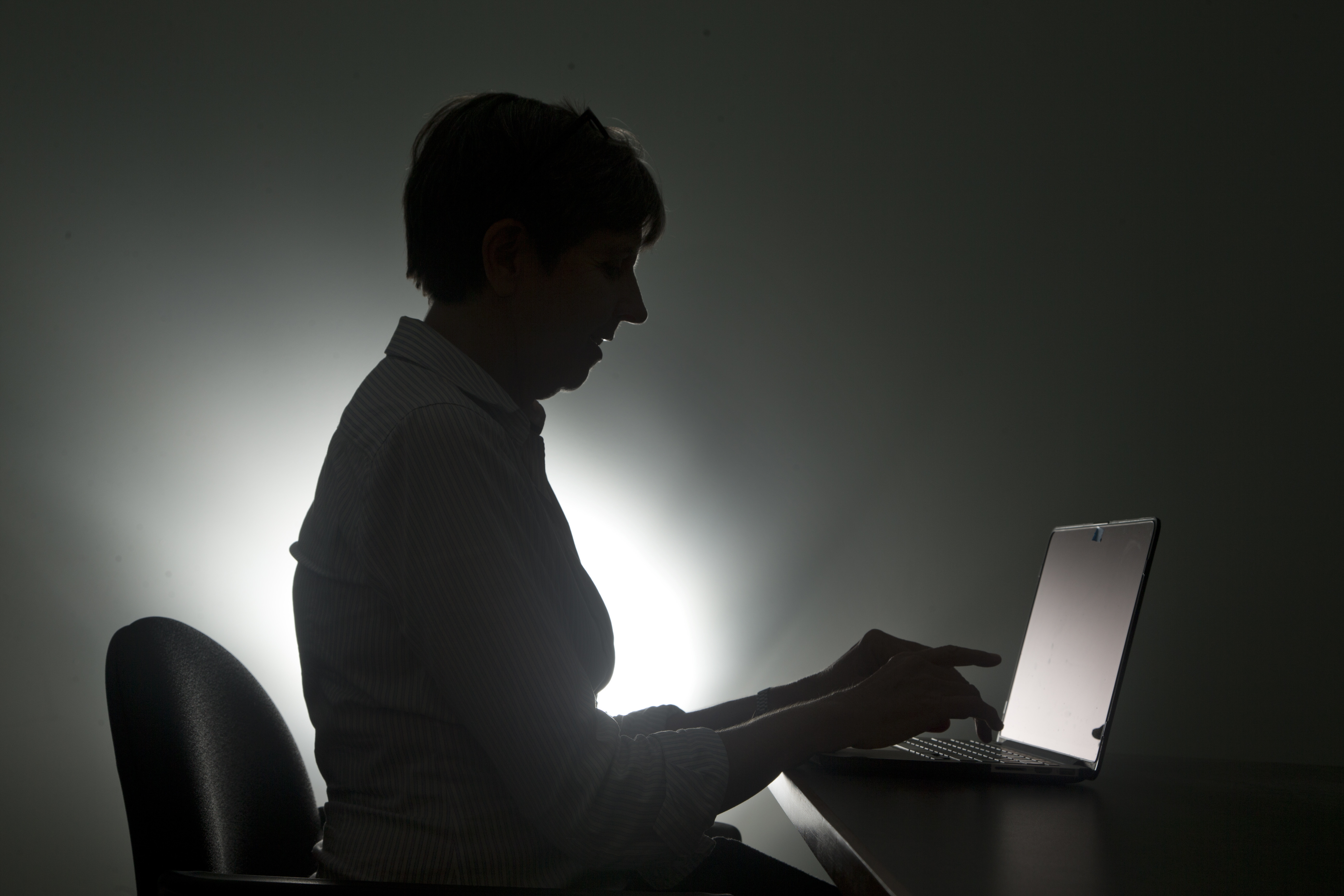 FILE - In this, Monday, Dec. 12, 2016, photo a woman types on her laptop, in Miami. (AP Photo/Wilfredo Lee, File)