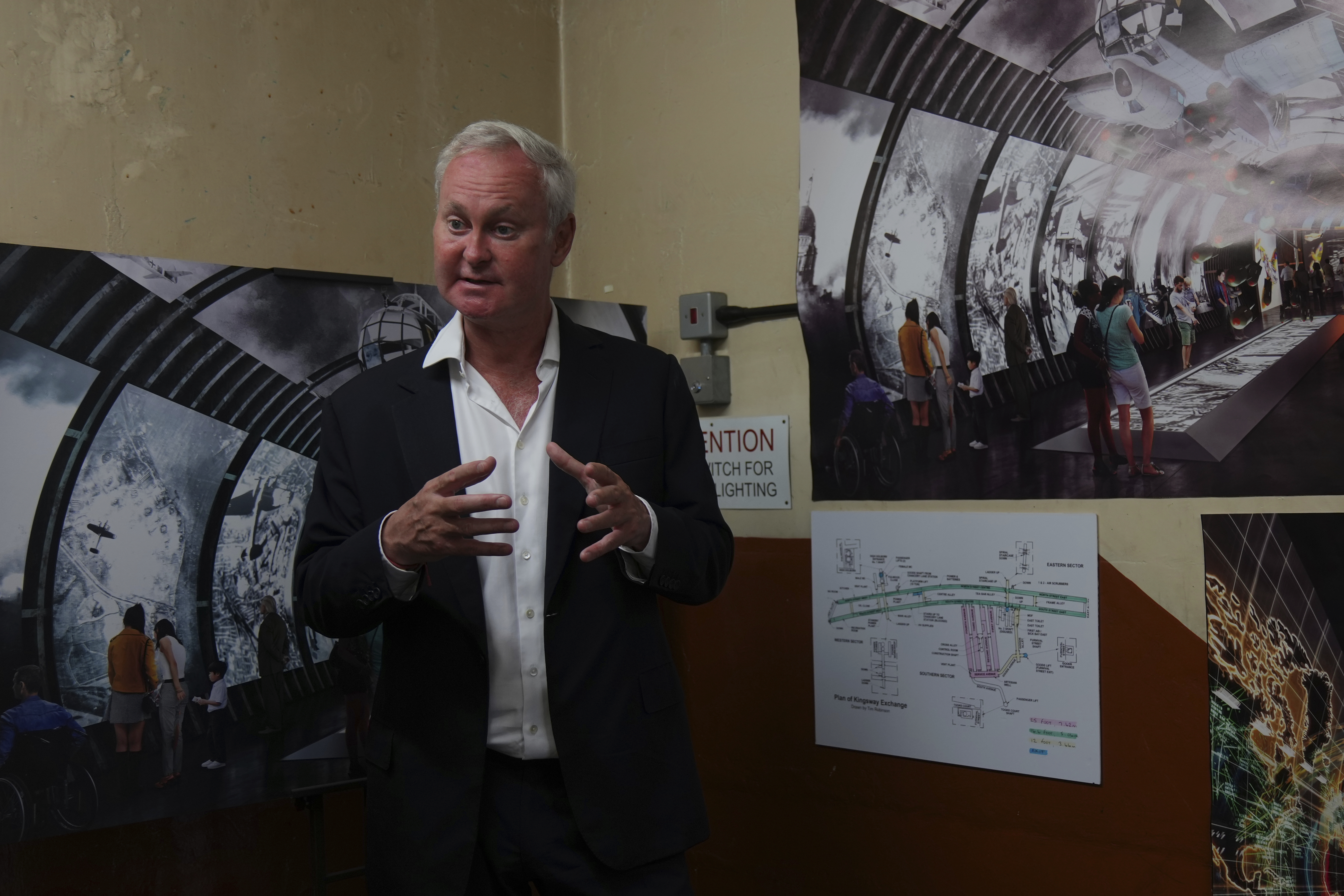 Angus Murray, CEO of The London Tunnels, gestures as he shows photos and diagrams relating to the history of the tunnels speaking during a press tour in London, Thursday, June 19, 2025. (AP Photo/Joanna Chan)