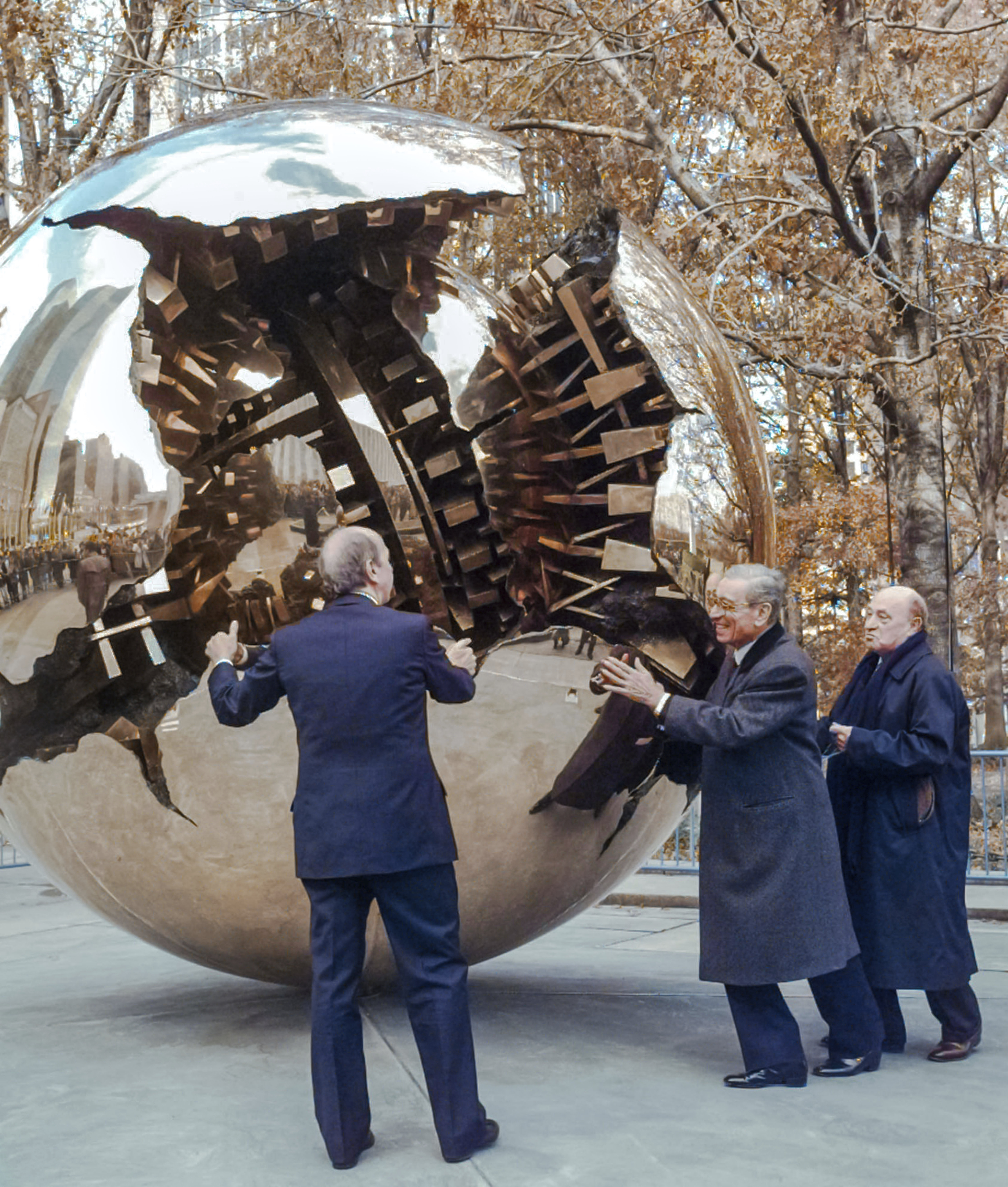 FILE-- Boutros Boutros-Ghali, center, secretary general of the United Nations, gives a push to Italian sculptor Arnaldo Pomodoro's, right, "Sphere Within a Sphere" during its unveiling at the United Nations, Thursday, Nov. 21, 1996. Helping him to rotate the 8-ton bronze sculpture is Italy's Foreign Minister Umberto Dini, left. (AP Photo/Mark Lennihan)