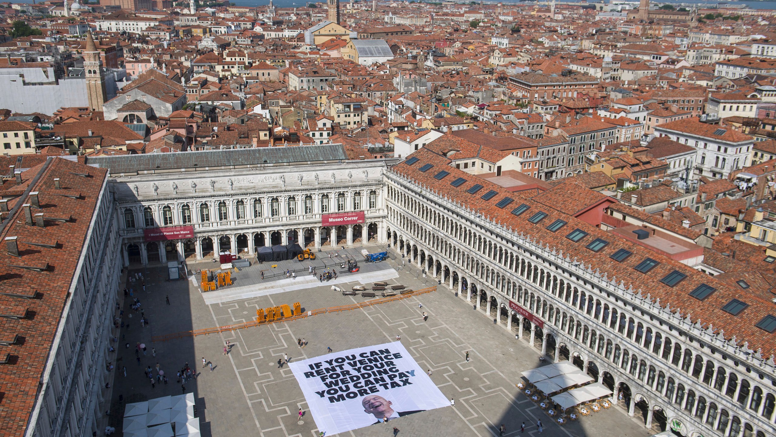 This photo released by Greenpeace shows a large banner against Amazon founder Jeff Bezos' planned wedding, in St. Mark Square, in Venice, Italy Monday, June 23, 2025. (Greenpeace via AP)