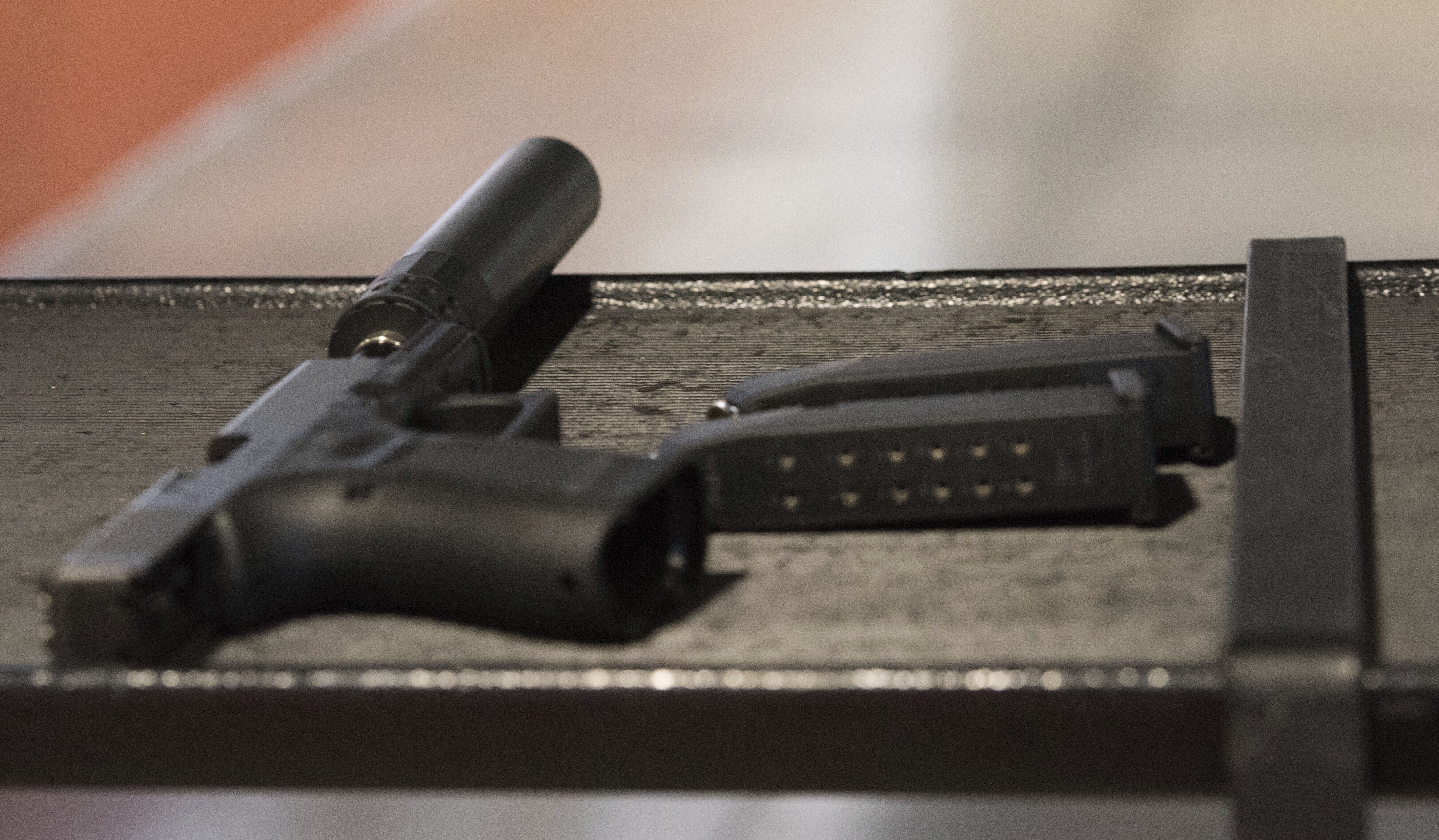 FILE - A handgun with a silencer and two magazines are shown at a gun range in Atlanta, Jan. 27, 2017. (AP Photo/Lisa Marie Pane, File)