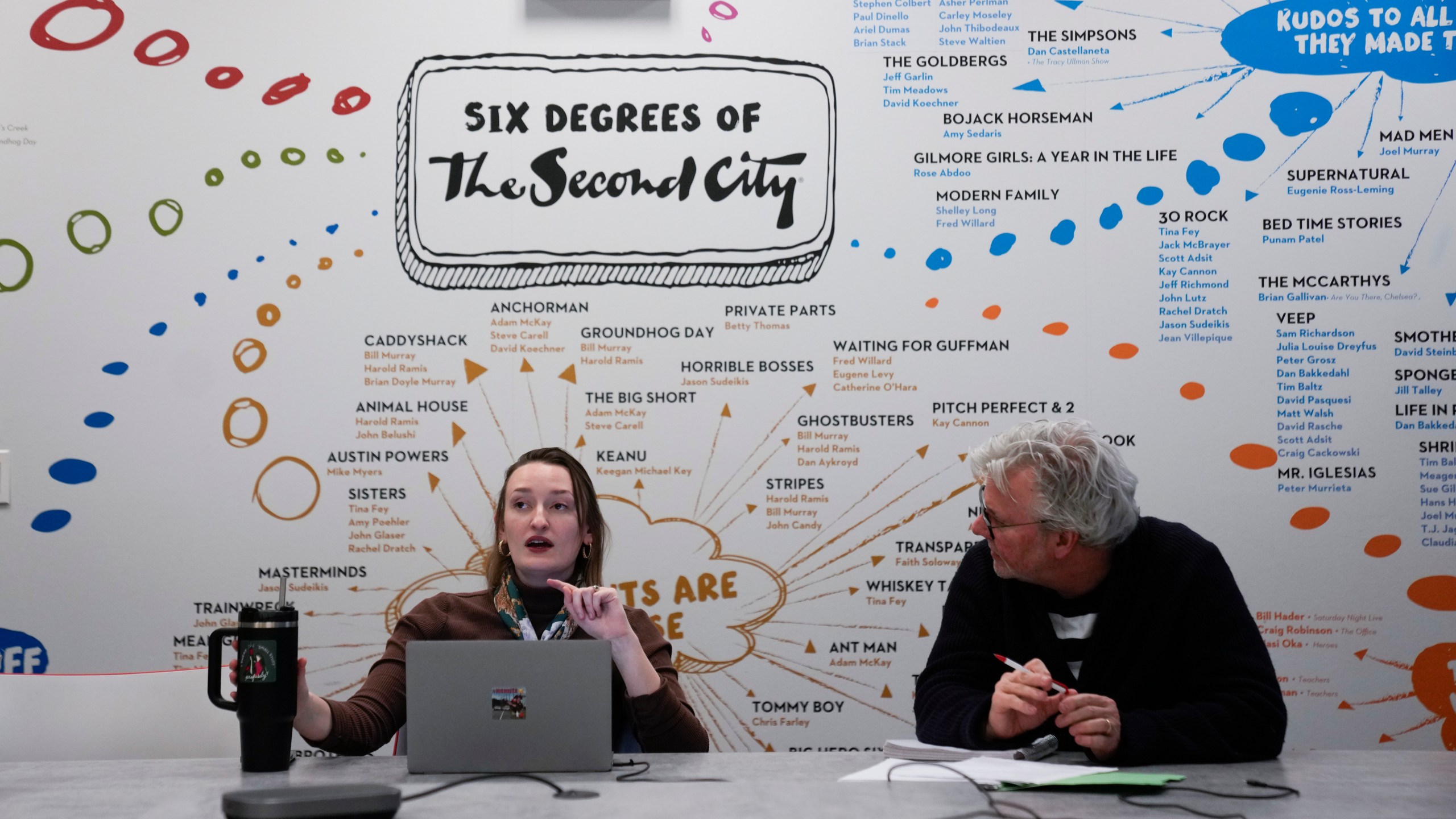 Strategic Client Partner Tree Branch, left, and Vice President, Creative Strategy, Innovation and Business Development Kelly Leonard talk during a planning meeting at The Second City improvisational comedy space, on March 26, 2025, in Chicago. (AP Photo/Erin Hooley)