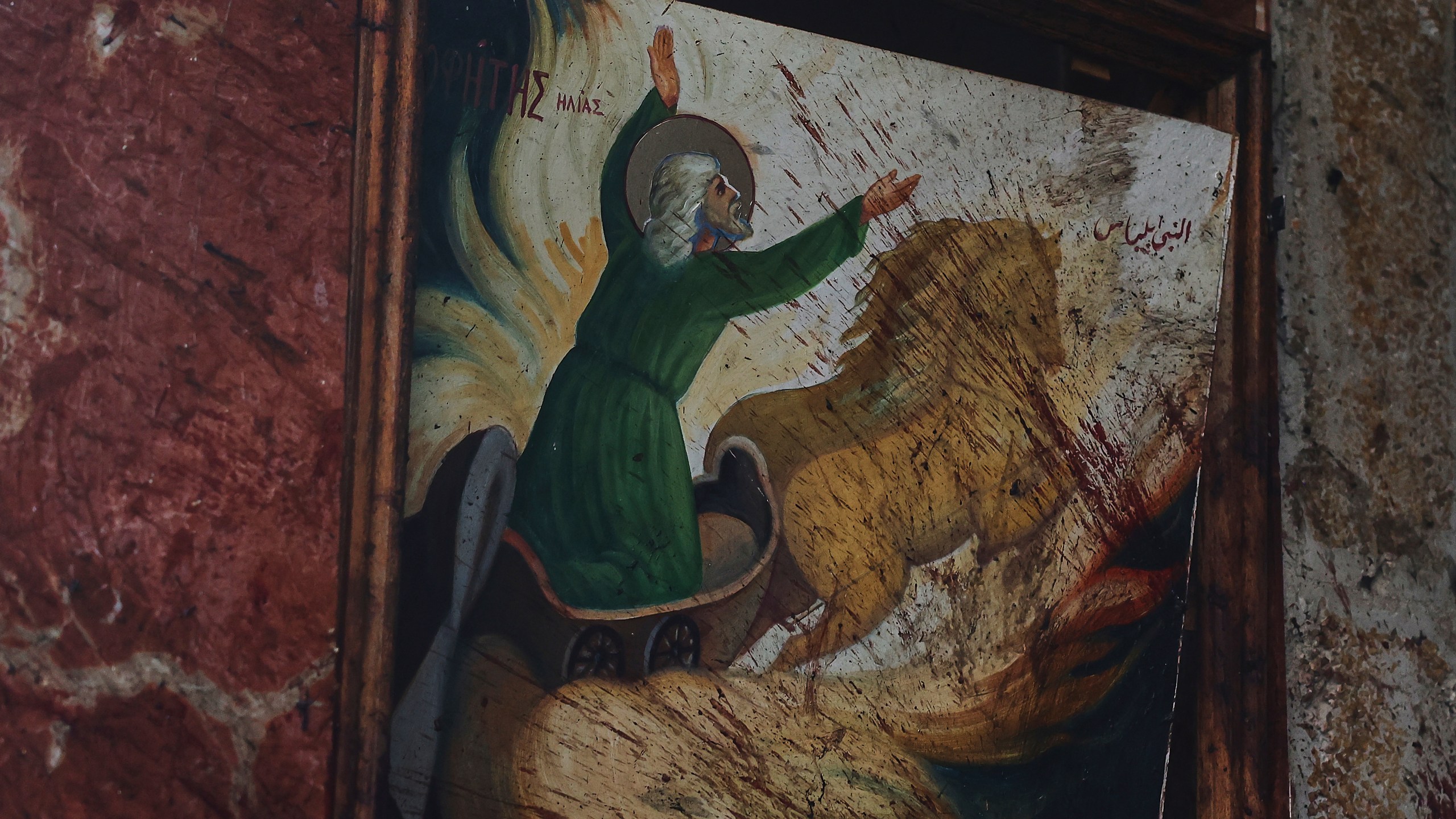 Blood stains a religious painting inside Mar Elias Church, where a suicide bomber detonated himself in Dweil’a, on the outskirts of Damascus, Syria, on Sunday, June 22, 2025. (AP Photo/Ghaith Alsayed)