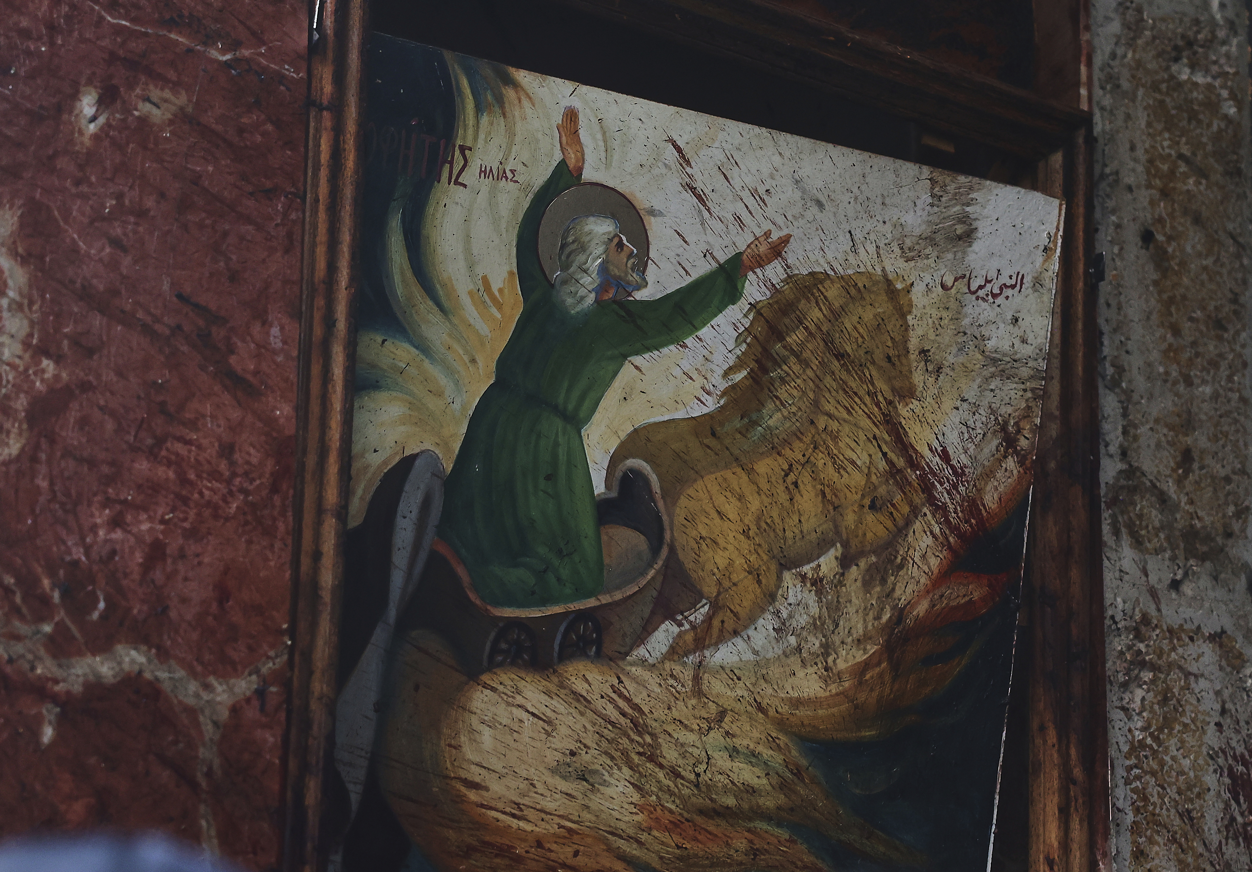 Blood stains a religious painting inside Mar Elias Church, where a suicide bomber detonated himself in Dweil’a, on the outskirts of Damascus, Syria, on Sunday, June 22, 2025. (AP Photo/Ghaith Alsayed)