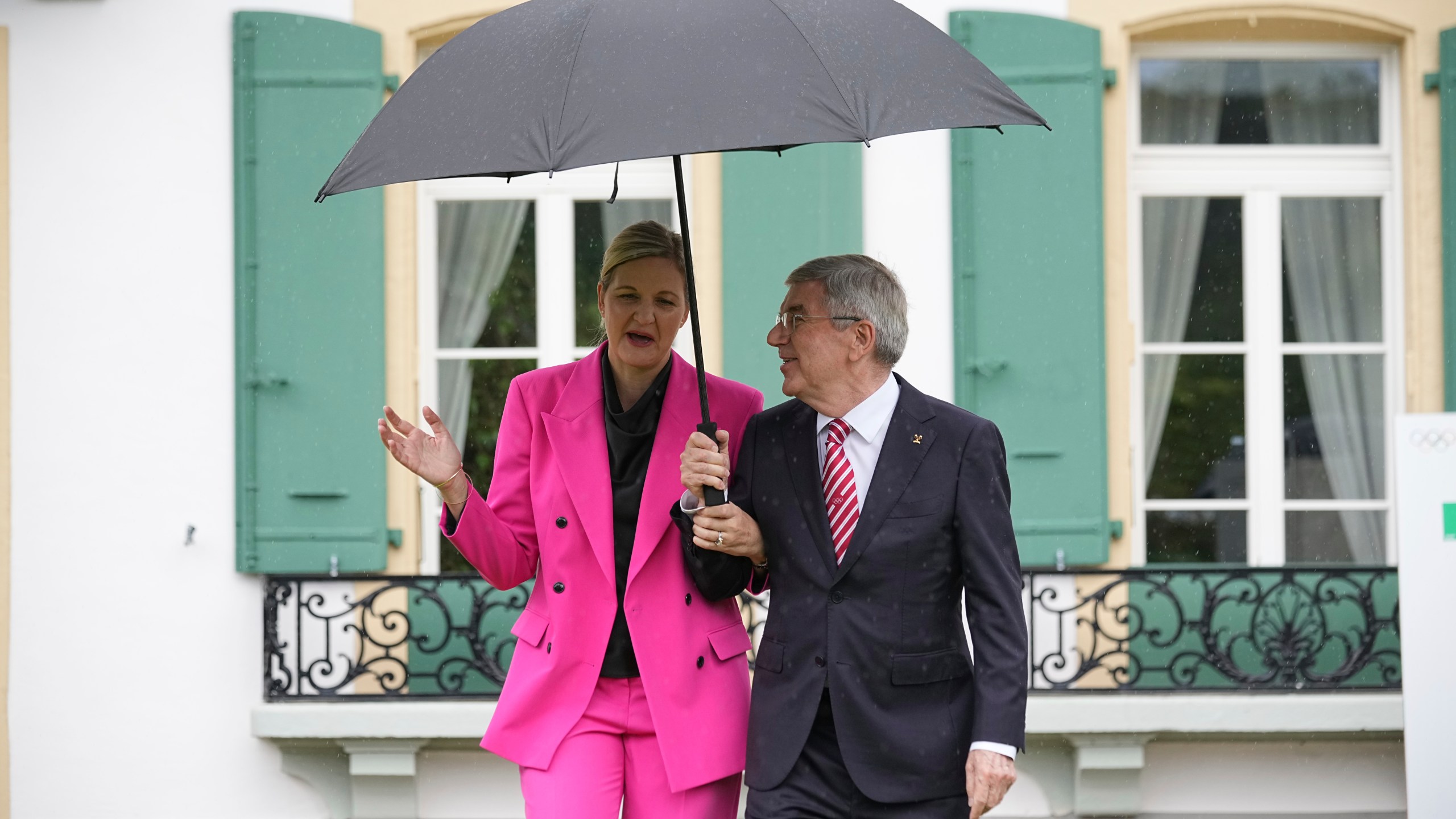 IOC President Thomas Bach, right, and President-elect Kirsty Coventry arrive for the handover ceremony of the IOC Presidency at Olympic House in Lausanne, Switzerland, Monday, June 23, 2025. (AP Photo/Laurent Cipriani)