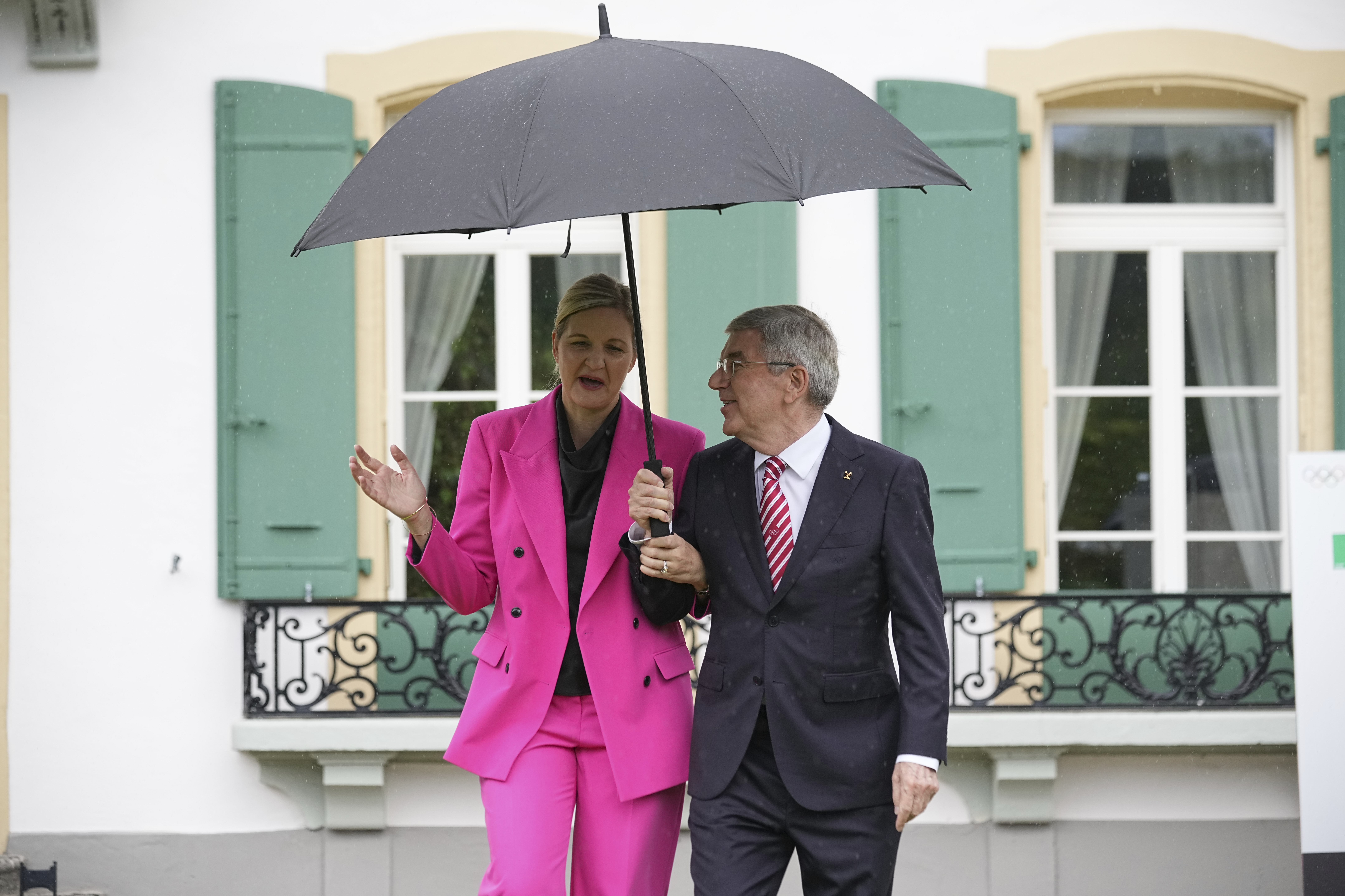 IOC President Thomas Bach, right, and President-elect Kirsty Coventry arrive for the handover ceremony of the IOC Presidency at Olympic House in Lausanne, Switzerland, Monday, June 23, 2025. (AP Photo/Laurent Cipriani)