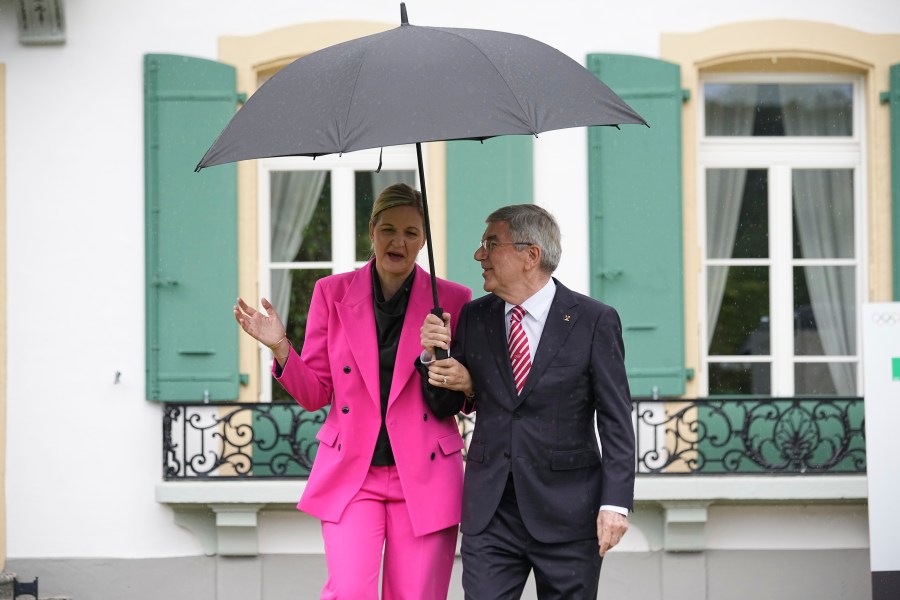 IOC President Thomas Bach, right, and President-elect Kirsty Coventry arrive for the handover ceremony of the IOC Presidency at Olympic House in Lausanne, Switzerland, Monday, June 23, 2025. (AP Photo/Laurent Cipriani)