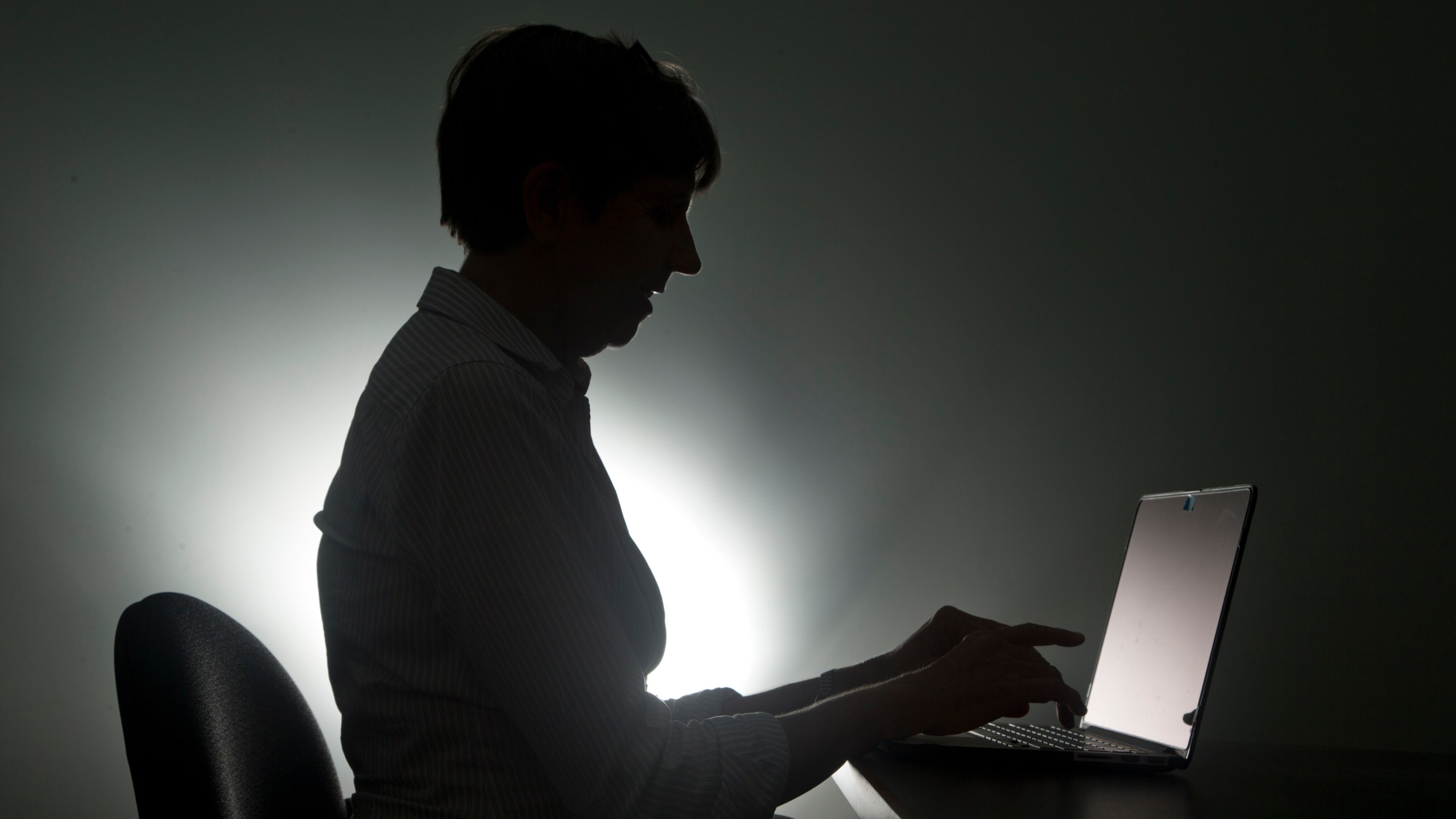 FILE - In this, Monday, Dec. 12, 2016, photo a woman types on her laptop, in Miami. (AP Photo/Wilfredo Lee, File)