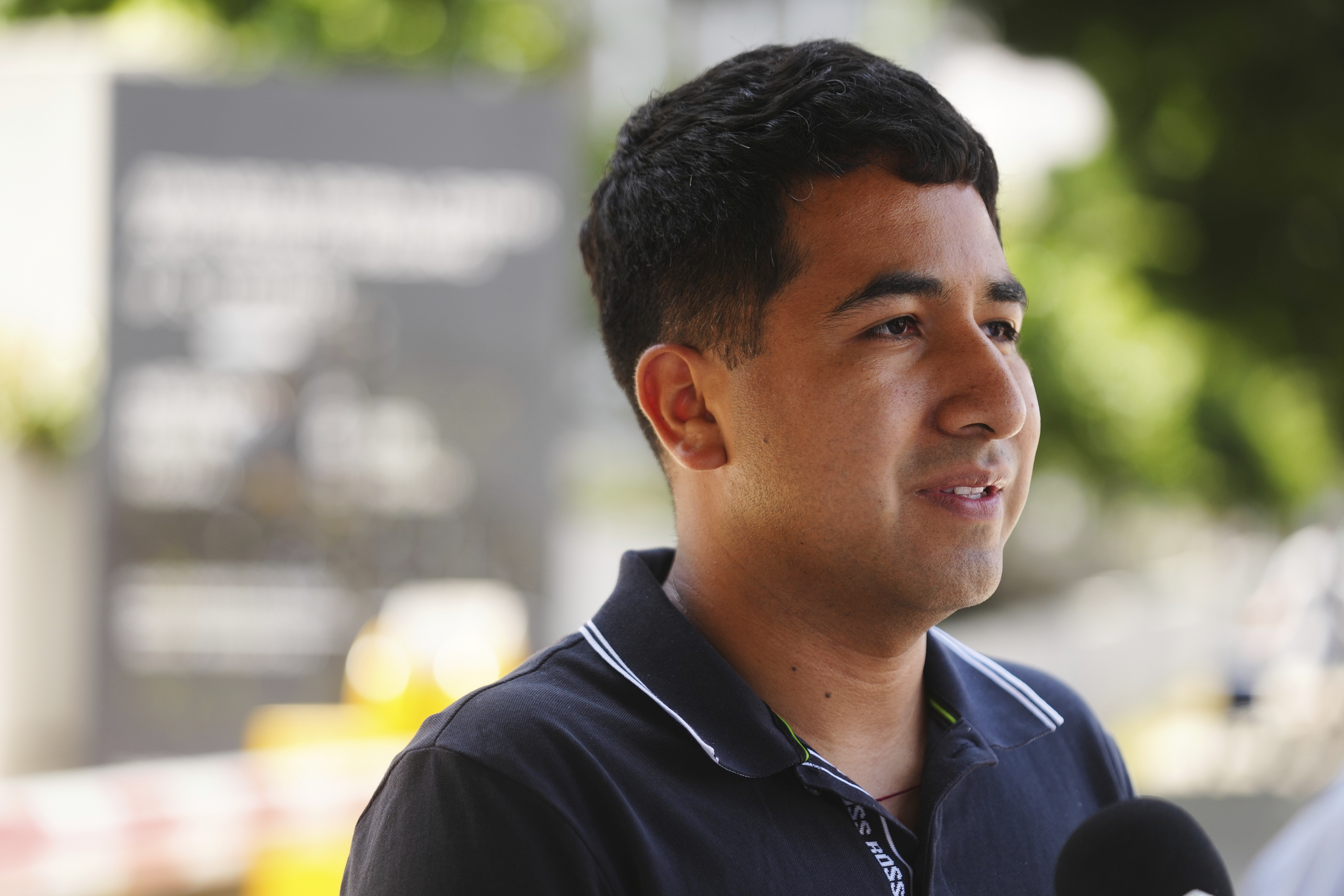 Alejandro Barranco conducts an interview as he arrives to check on his father Narciso, who was detained by federal agents, outside the Metropolitan Detention Center on Monday, June 23, 2025, in Los Angeles. (AP Photo/Damian Dovarganes)