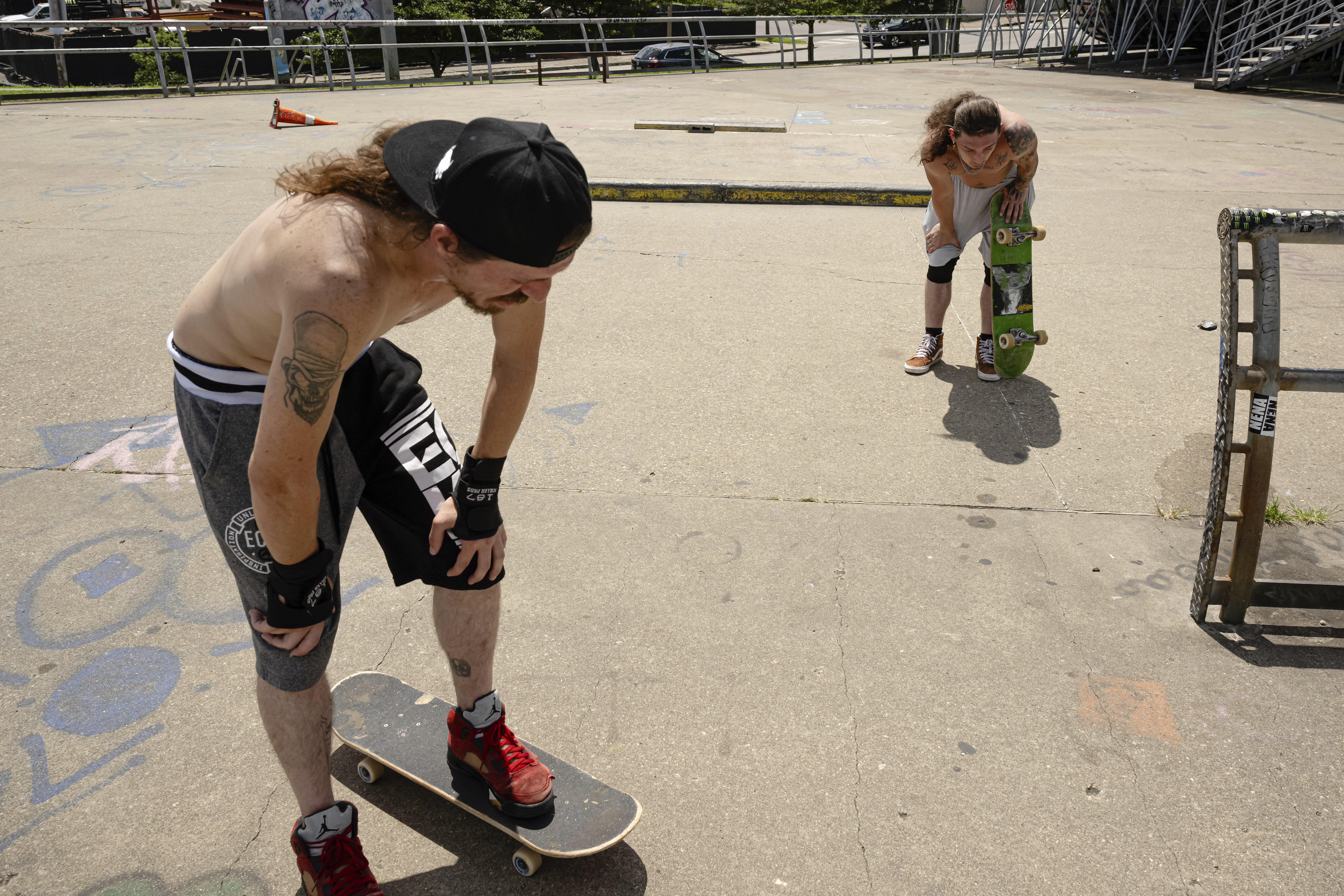 Skateboarders Anthony Eadens and Tommy Wright catch their breath after skating at the Dave Armstrong Extreme Park on Sunday, June 22, 2025, in Louisville, Ky. (AP Photo/Jon Cherry)