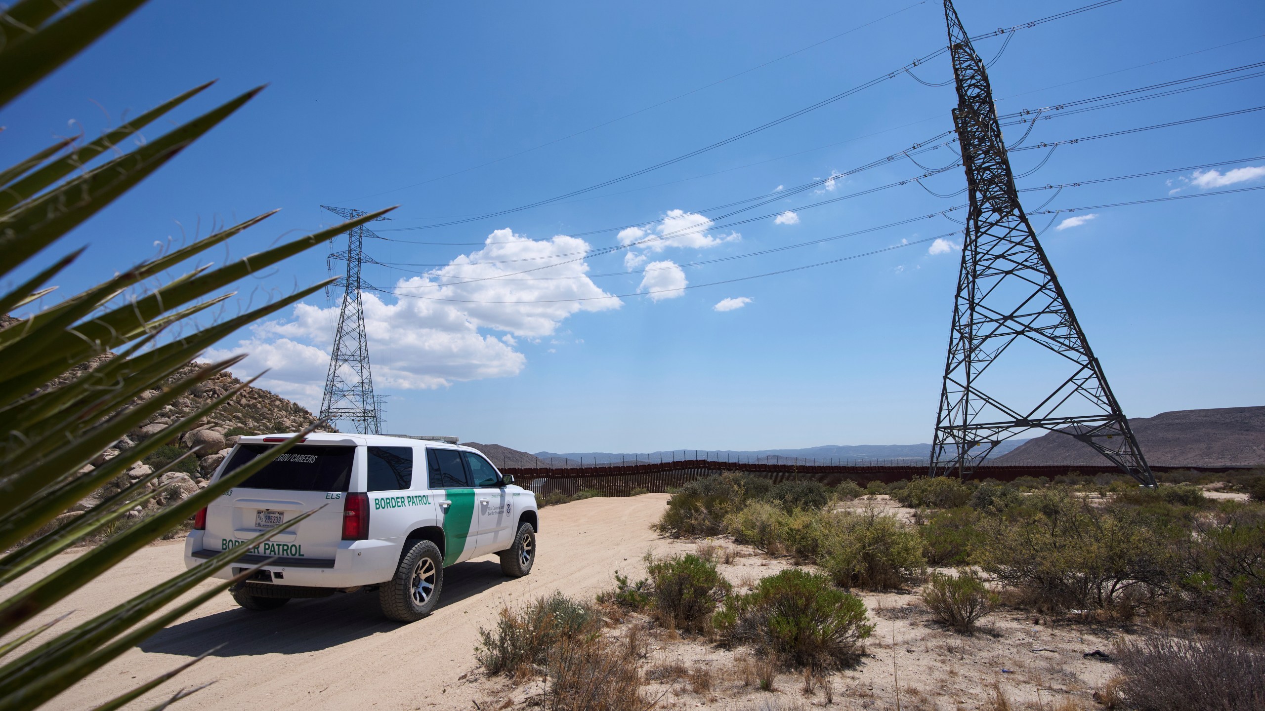 A Border Patrol vehicle sits near where, in years past, volunteers would see hundreds of migrants daily crossing the border separating Mexico and the United States, Thursday, June 5, 2025, near Jacumba Hot Springs, Calif. (AP Photo/Gregory Bull)