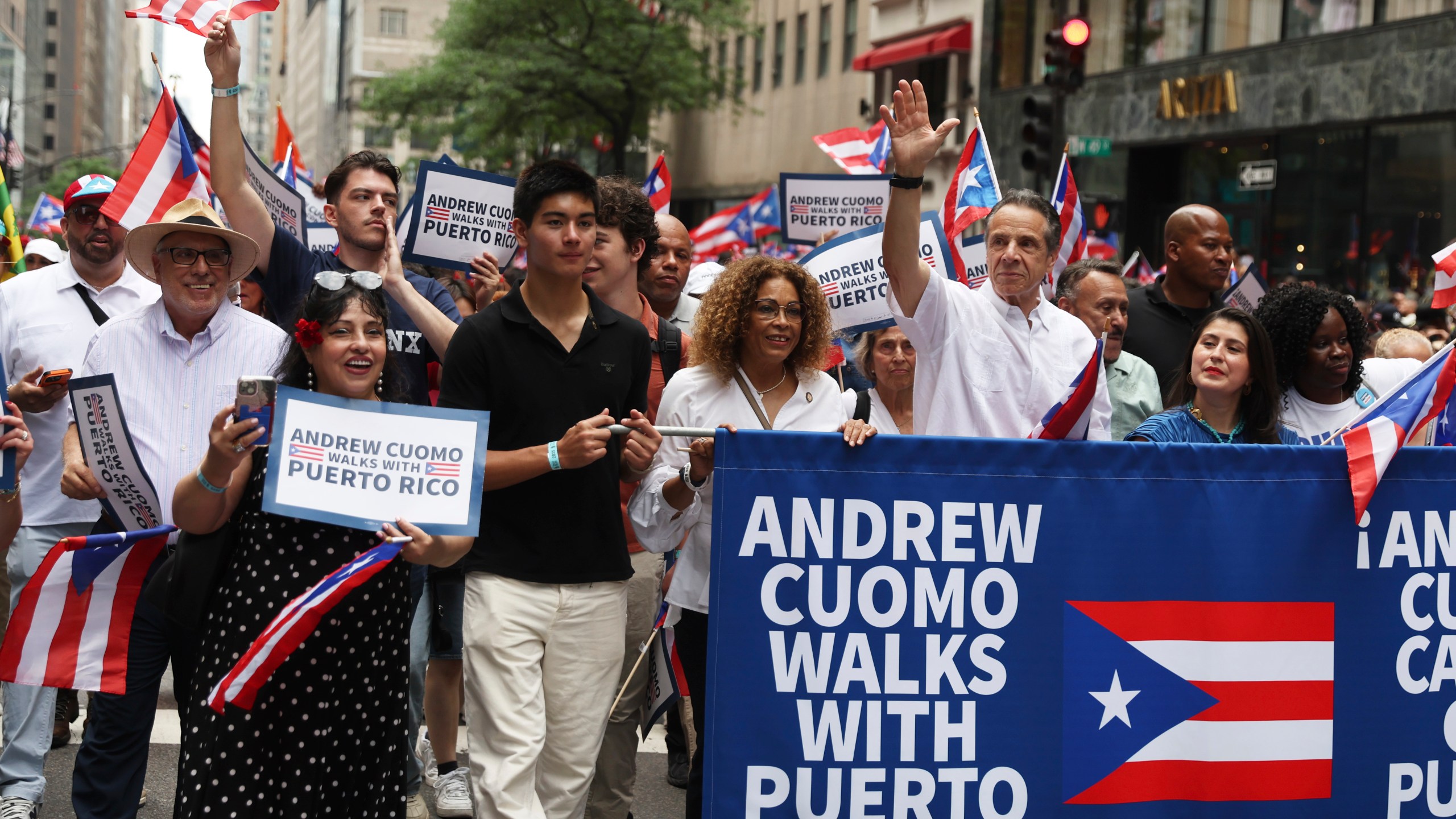 New York City mayoral candidate Andrew Cuomo, center, waves as he walks in the Puerto Rican Day Parade, Sunday, June 8, 2025, in New York. (AP Photo/Heather Khalifa)