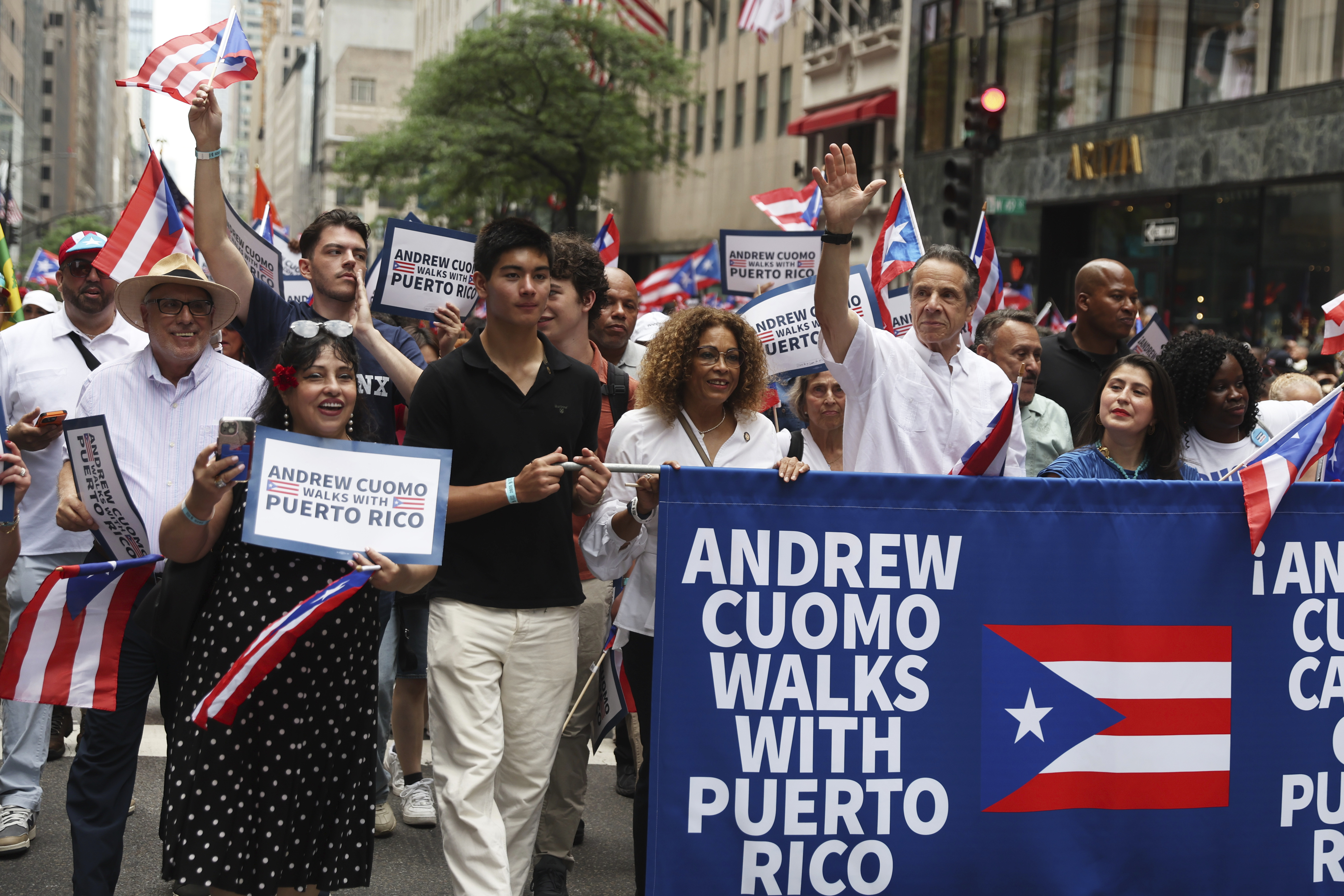 New York City mayoral candidate Andrew Cuomo, center, waves as he walks in the Puerto Rican Day Parade, Sunday, June 8, 2025, in New York. (AP Photo/Heather Khalifa)