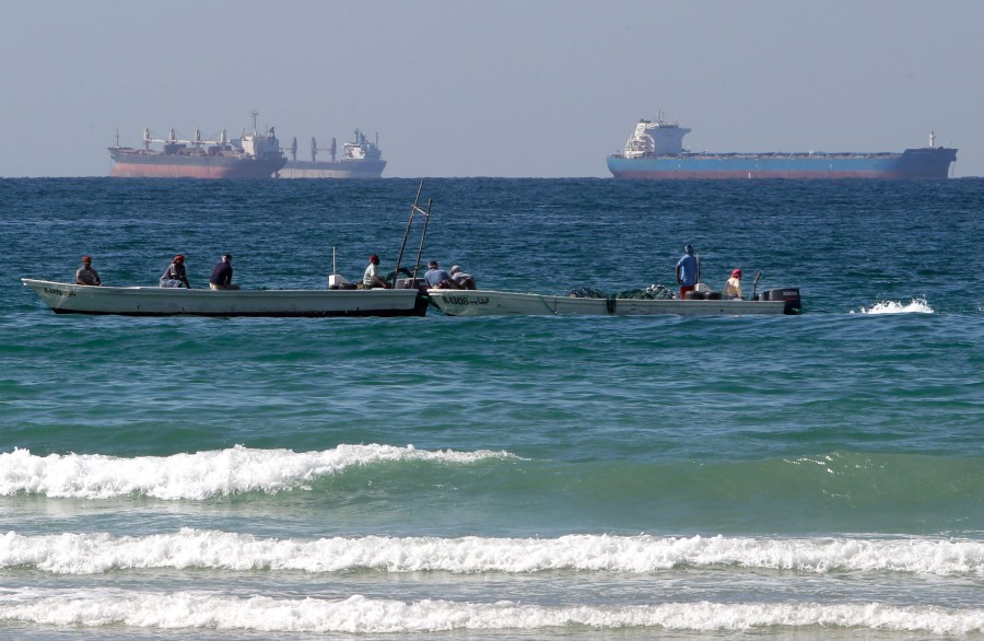 FILE - In this Jan. 19, 2012 file photo, fishing boats are seen in front of oil tankers south of the Strait of Hormuz, offshore the town of Ras Al Khaimah in United Arab Emirates. (AP Photo/Kamran Jebreili, File)