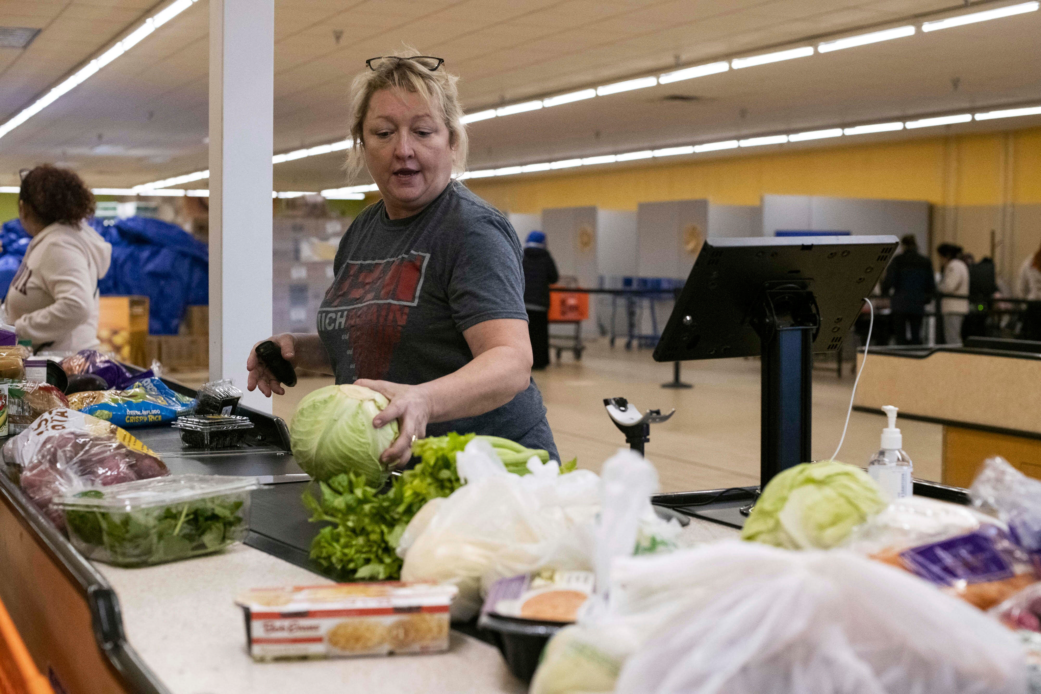 In this photo provided by Mid-Ohio Food Collective, volunteer Guyanna Slater from Mid-Ohio Food Collective, helps customers shop for free food at the Mid-Ohio Market in early June 2025, in Grove City, Ohio. (Mid-Ohio Food Collective via AP)