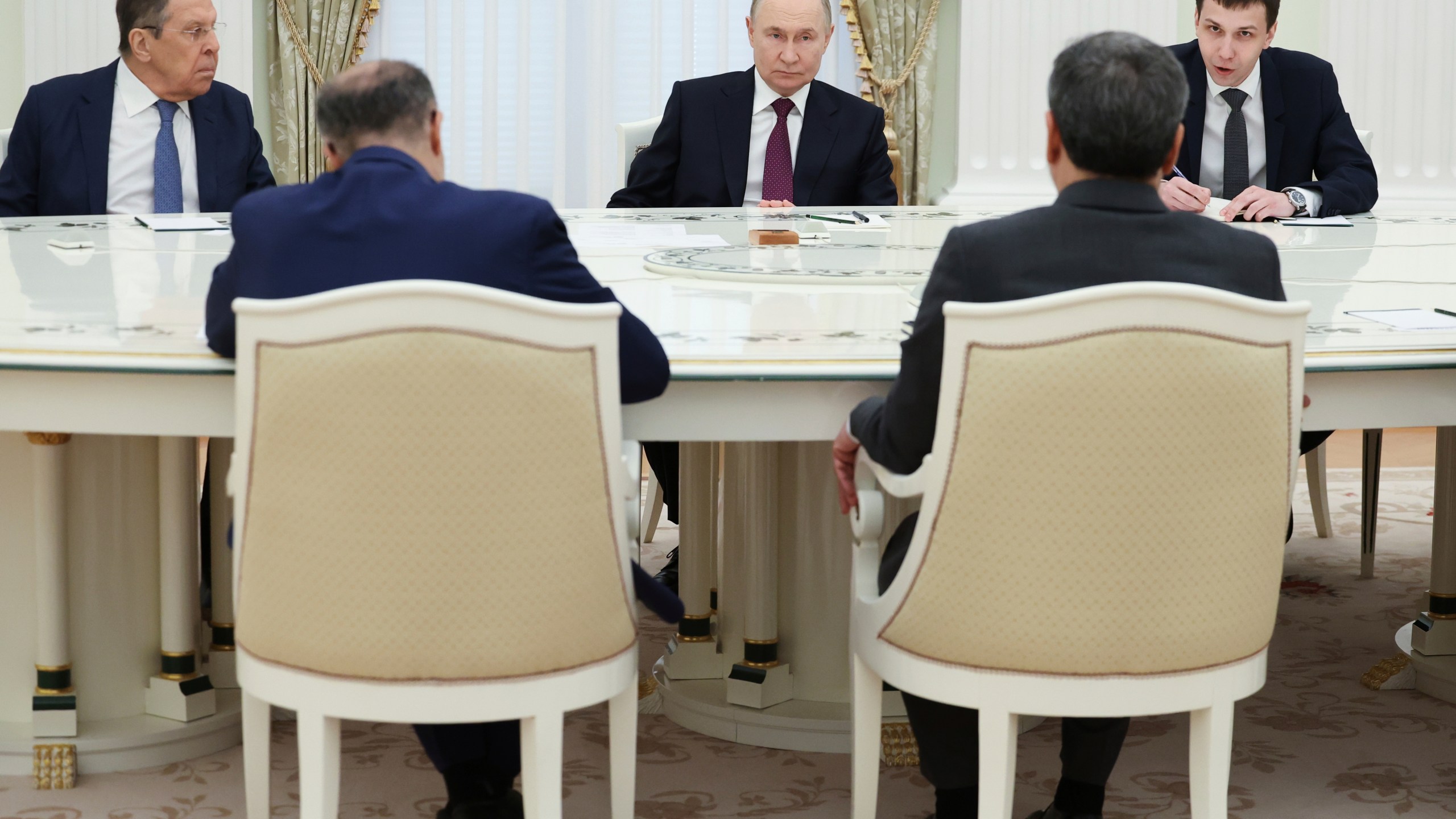 Russian President Vladimir Putin, center, listens to Iranian Foreign Minister Abbas Araghchi, right back to a camera, during their talks at the Kremlin in Moscow, Russia, Monday, June 23, 2025. (Alexander Kazakov, Sputnik, Kremlin Pool Photo via AP)