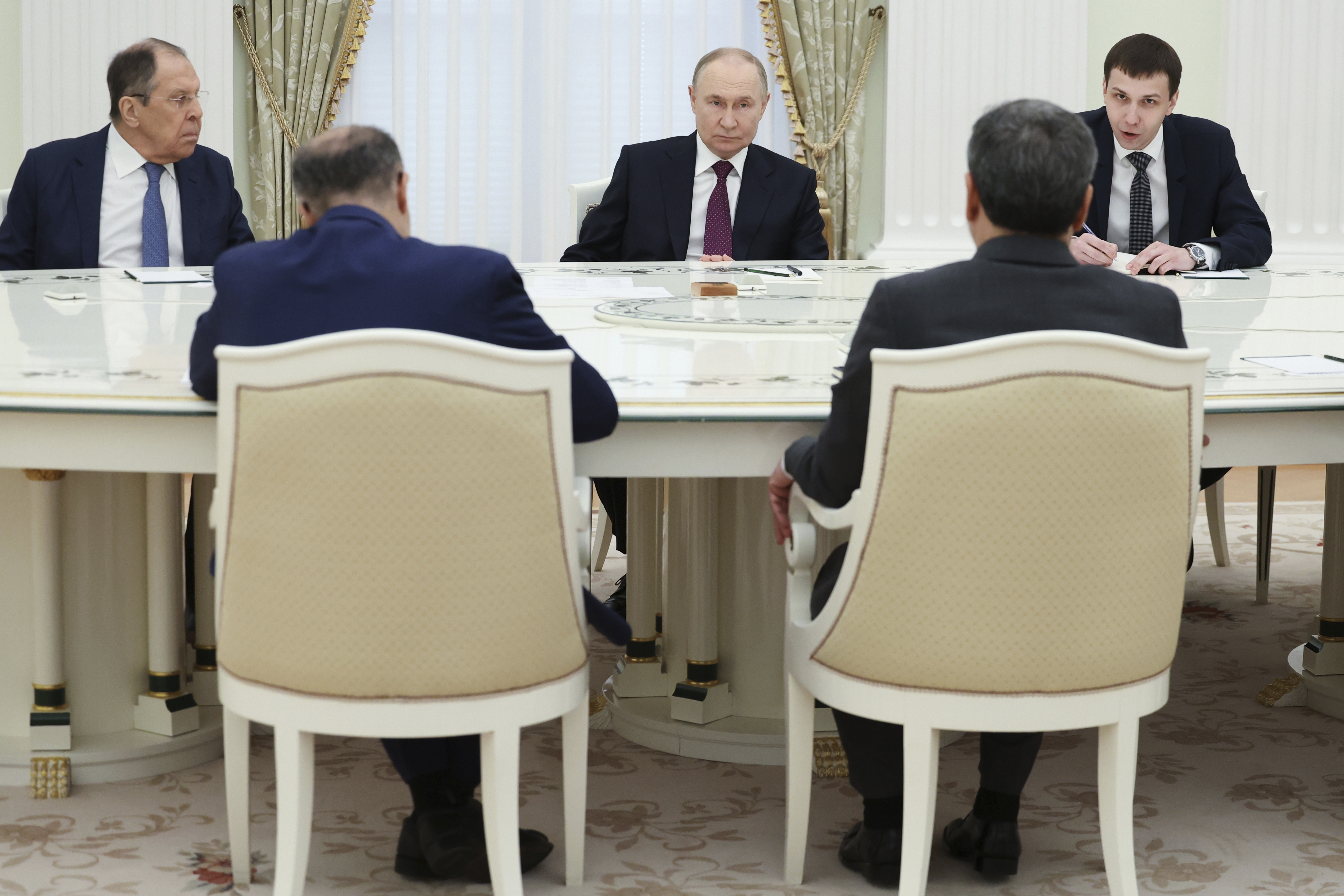 Russian President Vladimir Putin, center, listens to Iranian Foreign Minister Abbas Araghchi, right back to a camera, during their talks at the Kremlin in Moscow, Russia, Monday, June 23, 2025. (Alexander Kazakov, Sputnik, Kremlin Pool Photo via AP)