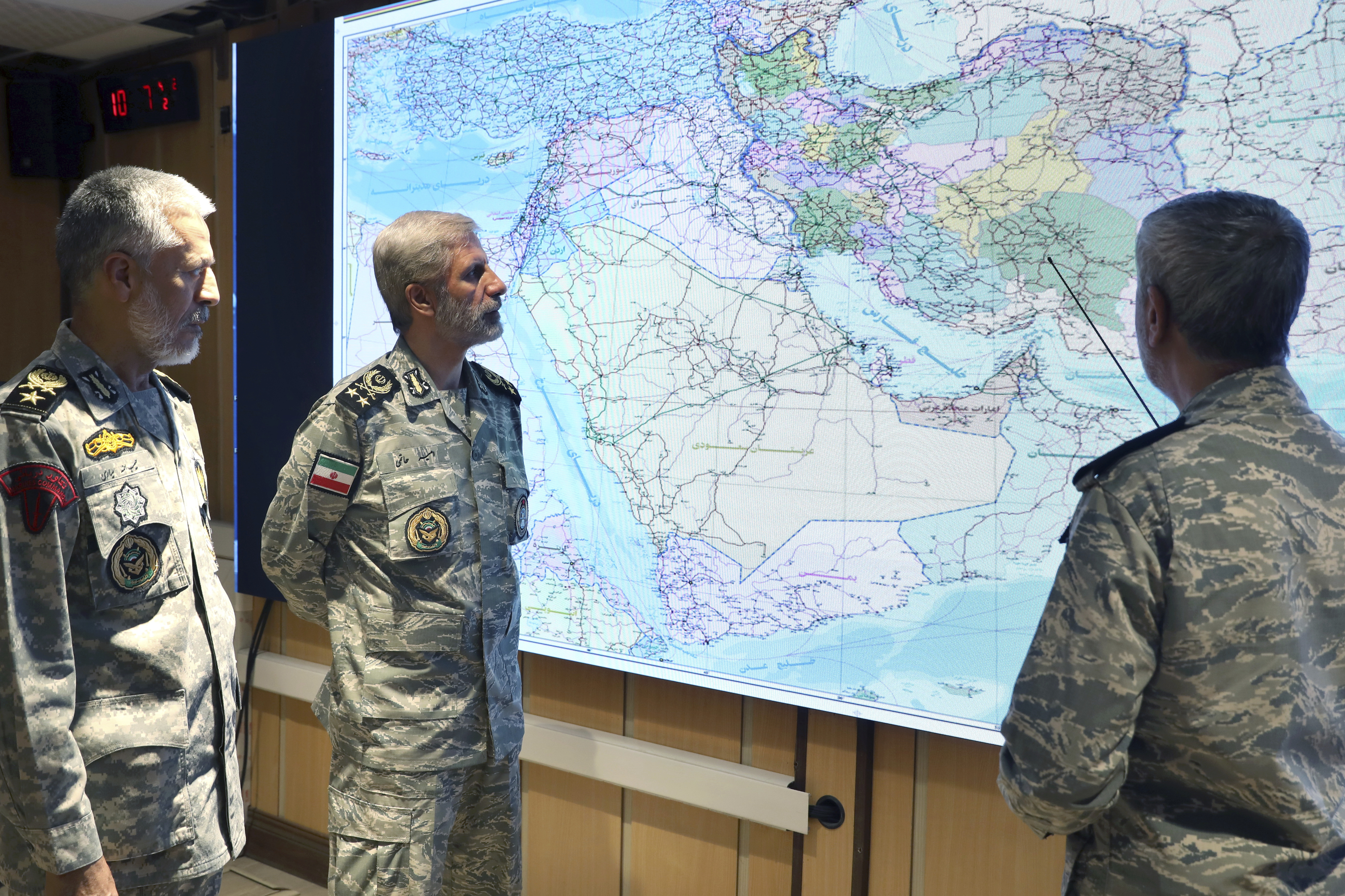 In this photo released on Monday, June 23, 2025, by Iranian army press service, Iran's army commander-in-chief Gen. Amir Hatami, center, Admiral Mahmoud Mousavi, right, and Admiral Habibollah Sayyari attend a meeting in Zolfaghar central headquarters, Iran. (Iranian Army Press Service via AP)