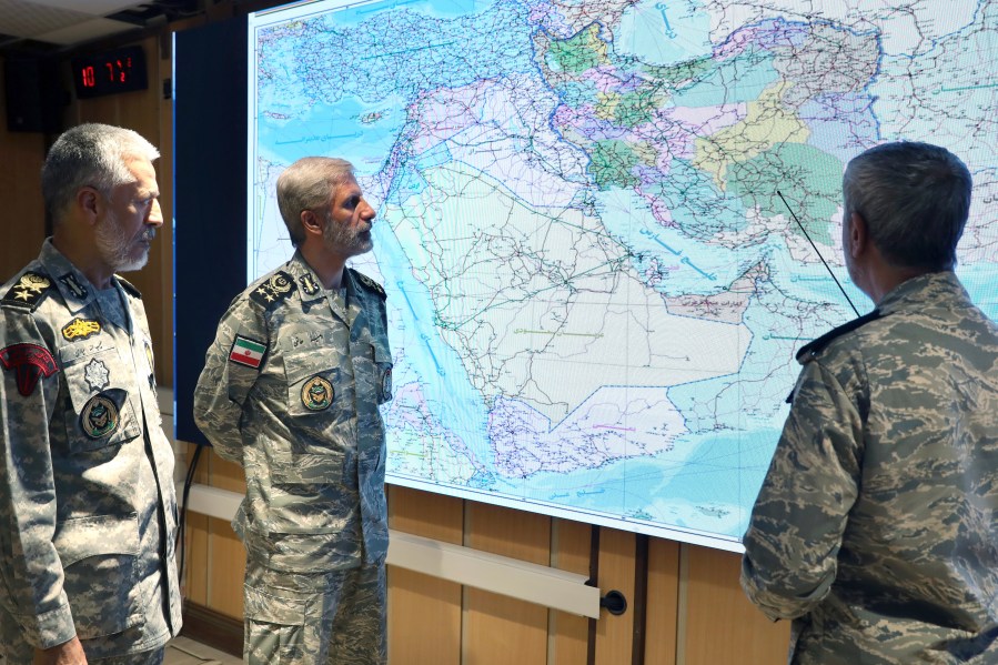 In this photo released on Monday, June 23, 2025, by Iranian army press service, Iran's army commander-in-chief Gen. Amir Hatami, center, Admiral Mahmoud Mousavi, right, and Admiral Habibollah Sayyari attend a meeting in Zolfaghar central headquarters, Iran. (Iranian Army Press Service via AP)
