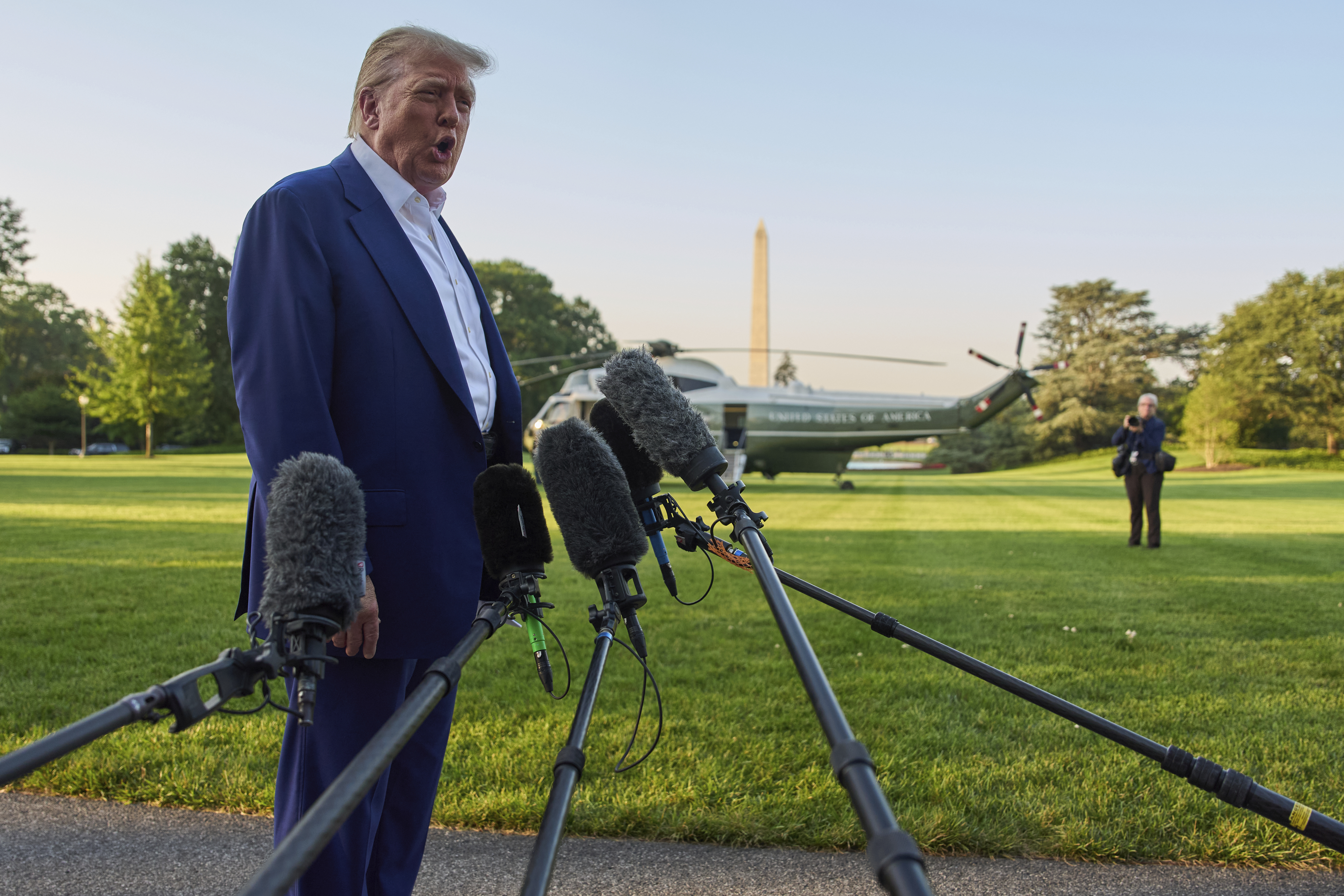 President Donald Trump speaks with reporters before boarding Marine One on the South Lawn of the White House, Tuesday, June 24, 2025, in Washington. (AP Photo/Evan Vucci)