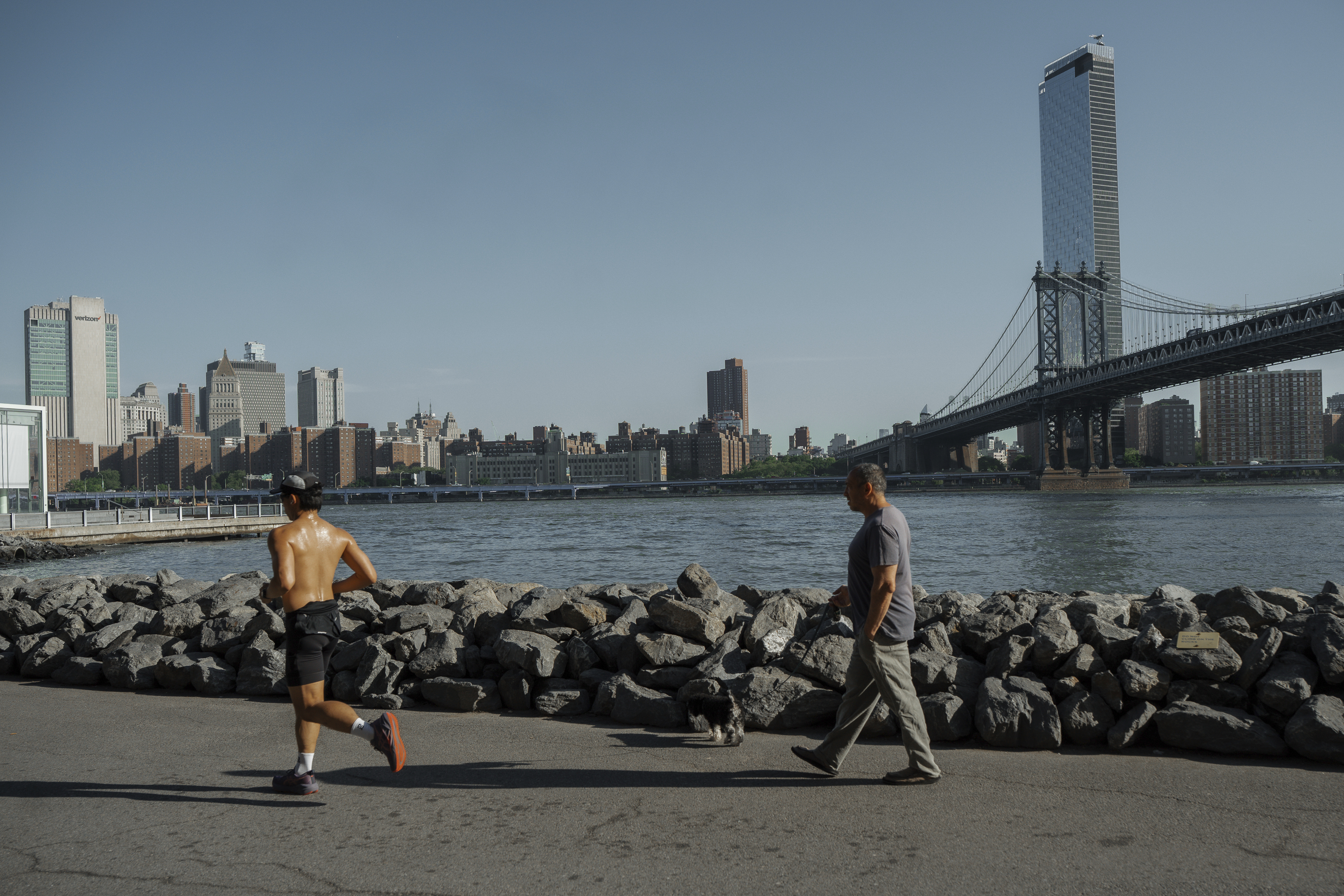 People exercise on the Brooklyn waterfront during a heatwave on Tuesday, June 24, 2025, in New York. (AP Photo/Olga Fedorova)