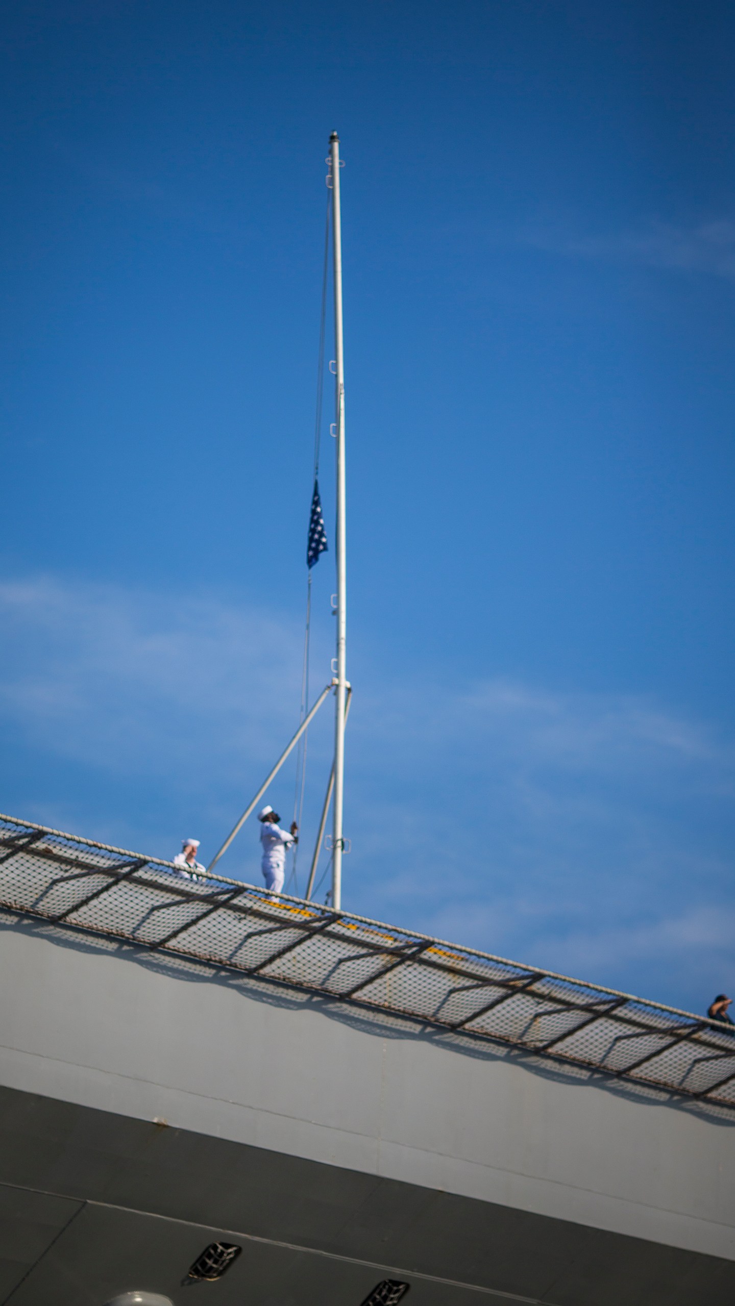 Sailors raise the Colors as the USS Gerald R. Ford aircraft carrier prepares to go underway from Naval Station Norfolk, Tuesday, June 24, 2025, in Norfolk, Va. (AP Photo/John Clark)