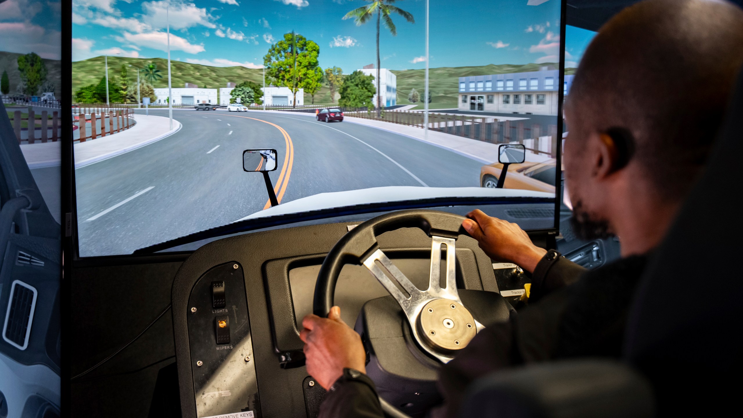Mohammed Kamal practices handling a tractor-trailer truck in a driving simulator at the Driving Academy on Tuesday, June 10, 2025 in Linden, N.J. (AP Photo/Angelina Katsanis)