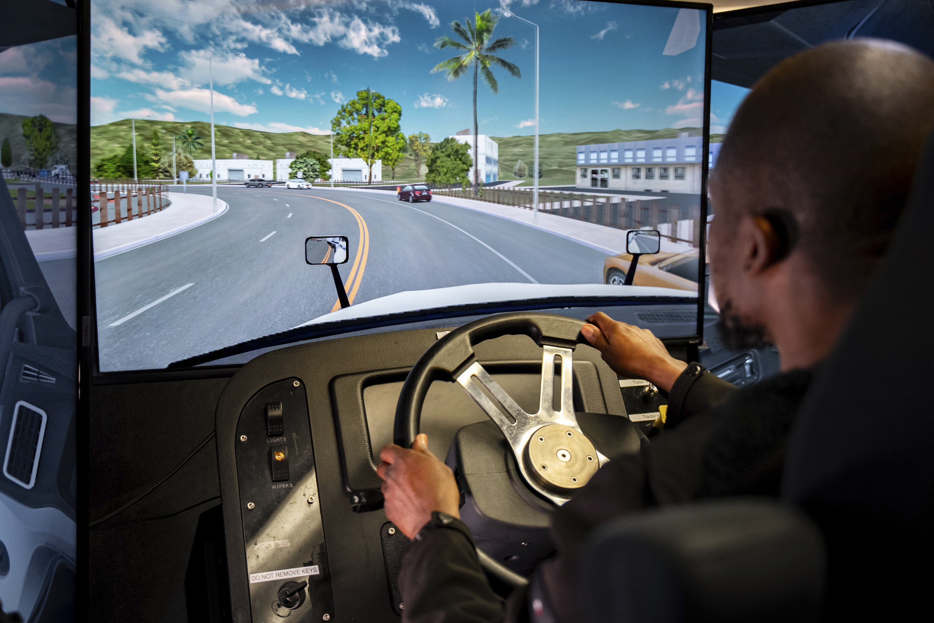 Mohammed Kamal practices handling a tractor-trailer truck in a driving simulator at the Driving Academy on Tuesday, June 10, 2025 in Linden, N.J. (AP Photo/Angelina Katsanis)