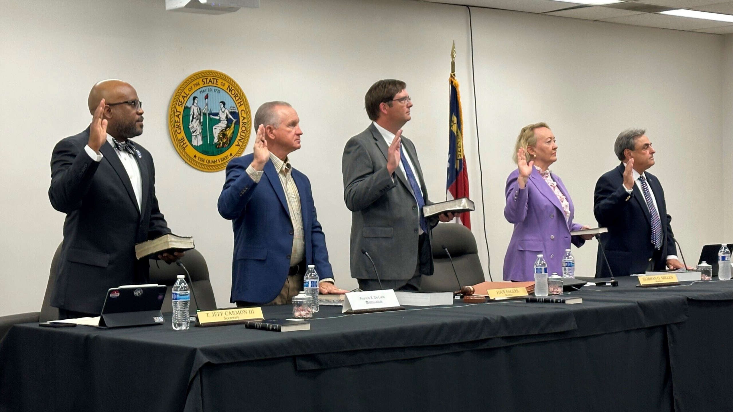 FILE - Newly appointed members of the North Carolina State Board of Elections, from left, Jeff Carmon, Francis De Luca, Stacy "Four" Eggers, Siobhan O'Duffy Millen and Bob Rucho, take their oaths of office at the Dobbs Building in Raleigh, N.C., on May 7, 2025 (AP Photo/Gary D. Robertson, file)