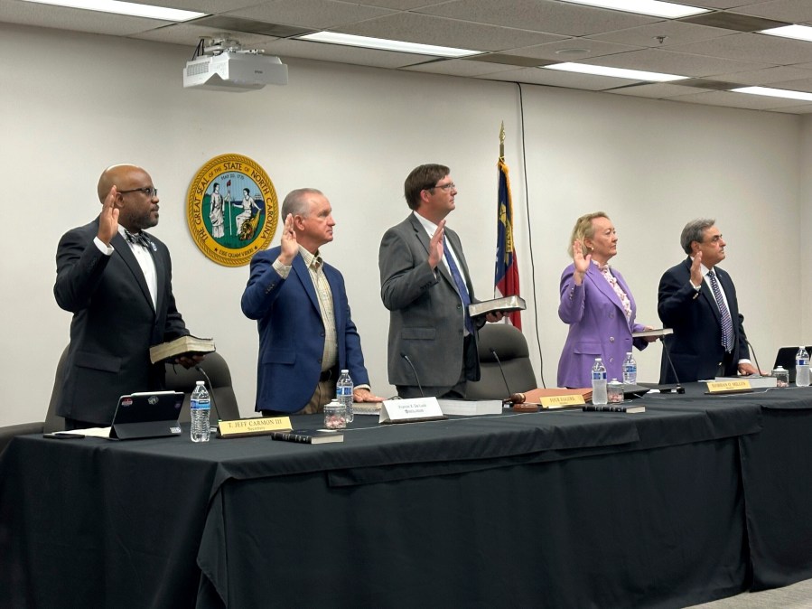 FILE - Newly appointed members of the North Carolina State Board of Elections, from left, Jeff Carmon, Francis De Luca, Stacy "Four" Eggers, Siobhan O'Duffy Millen and Bob Rucho, take their oaths of office at the Dobbs Building in Raleigh, N.C., on May 7, 2025 (AP Photo/Gary D. Robertson, file)