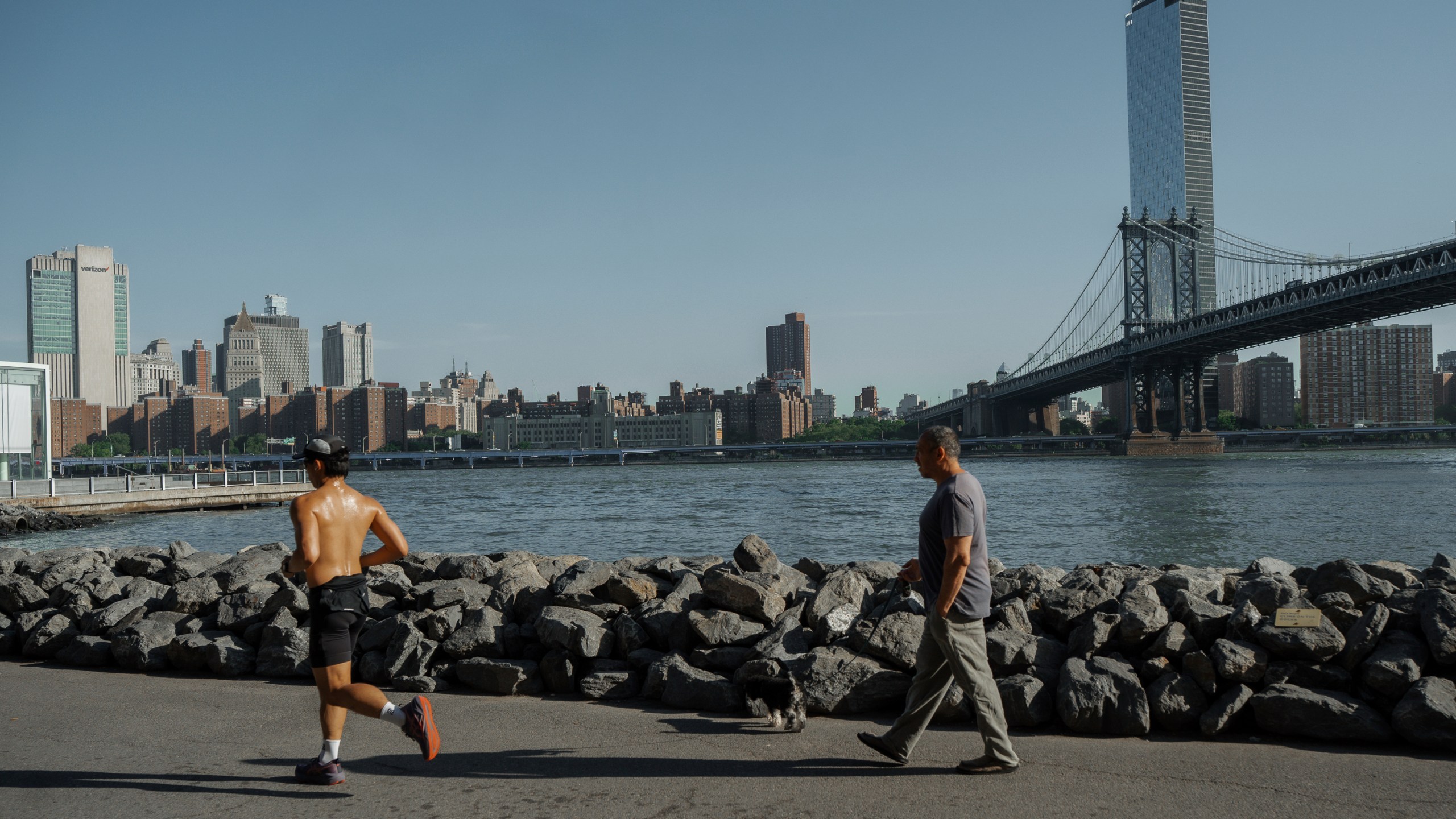 People exercise on the Brooklyn waterfront during a heatwave on Tuesday, June 24, 2025, in New York. (AP Photo/Olga Fedorova)