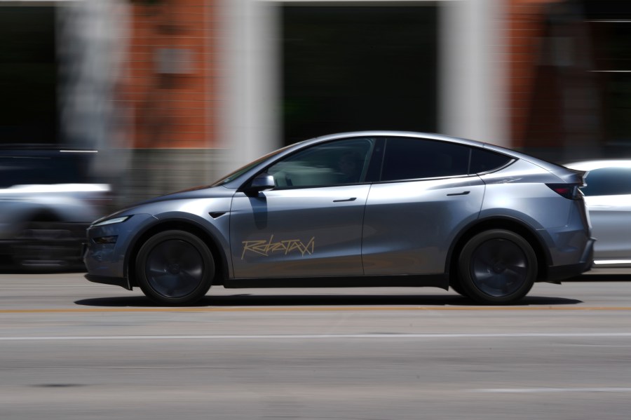 A driverless Tesla robotaxi, a ride-booking service, moves through traffic, Sunday, June 22, 2025, in Austin, Texas. (AP Photo/Eric Gay)
