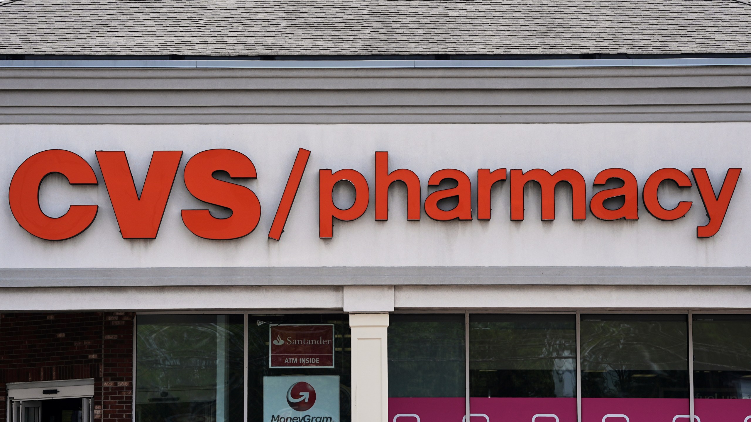 FILE - Signage hangs above a CVS pharmacy location in Philadelphia, June 6, 2025. (AP Photo/Matt Rourke, File)