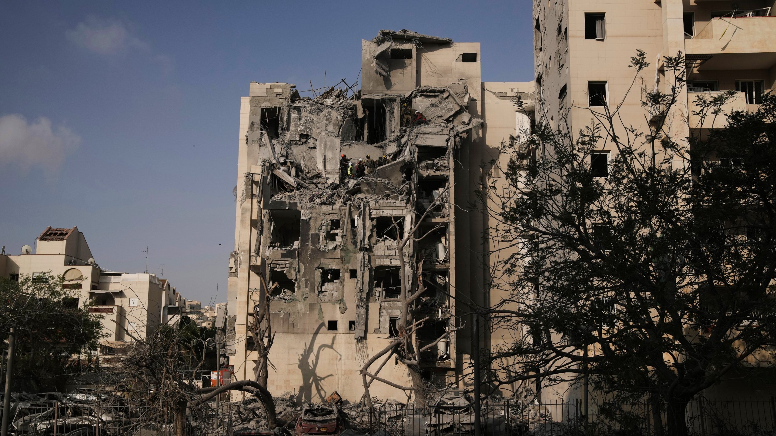Israeli soldiers and a rescue team search for survivors amid the rubble of residential buildings destroyed by an Iranian missile strike that killed several people, in Beersheba, Israel, on Tuesday, June 24, 2025. (AP Photo/Leo Correa)