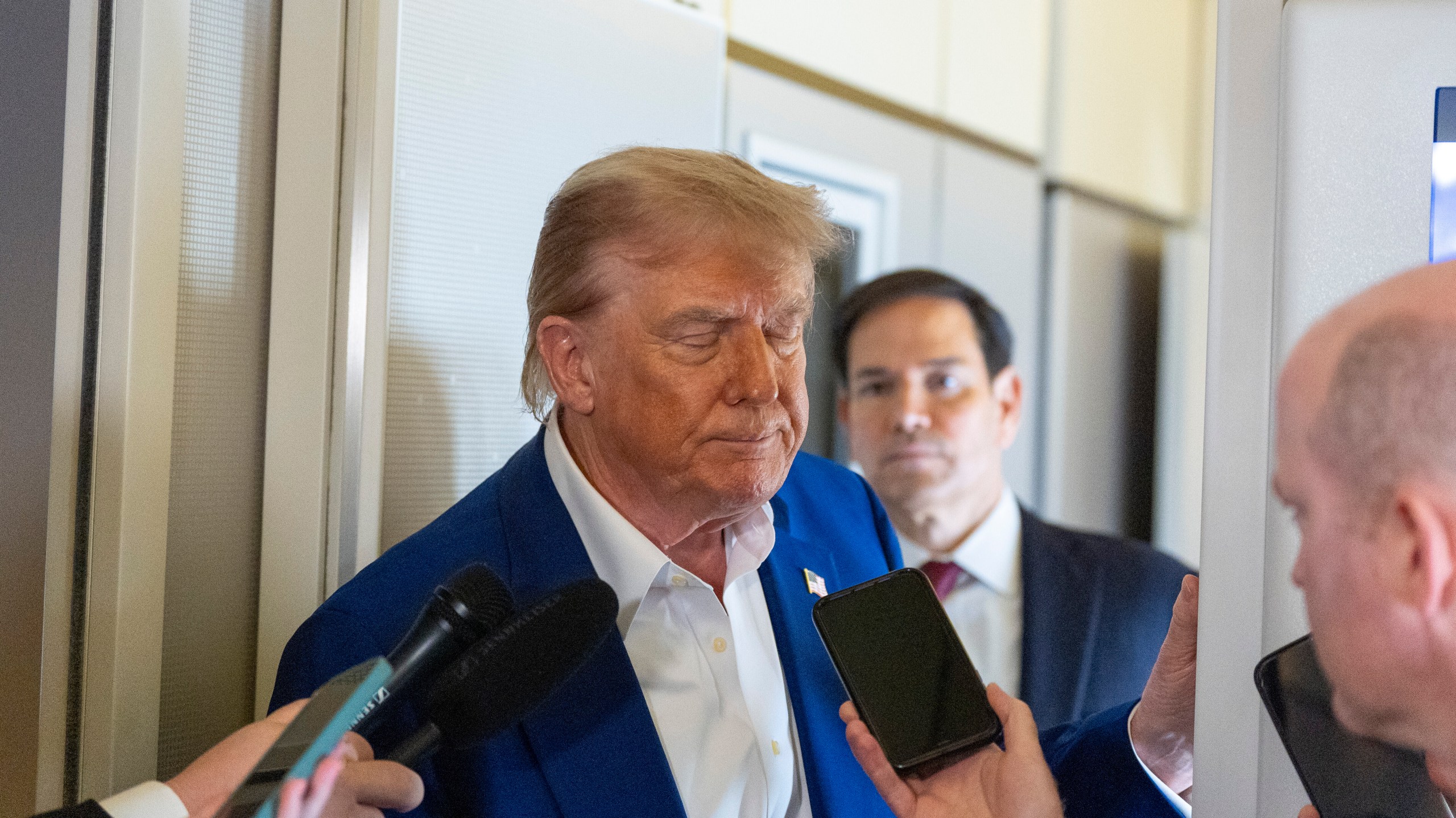 President Donald Trump turns to depart after speaking with reporters on Air Force One while in flight from Joint Base Andrews, Md., to Amsterdam, Netherlands, Tuesday, June 24, 2025. (AP Photo/Alex Brandon)