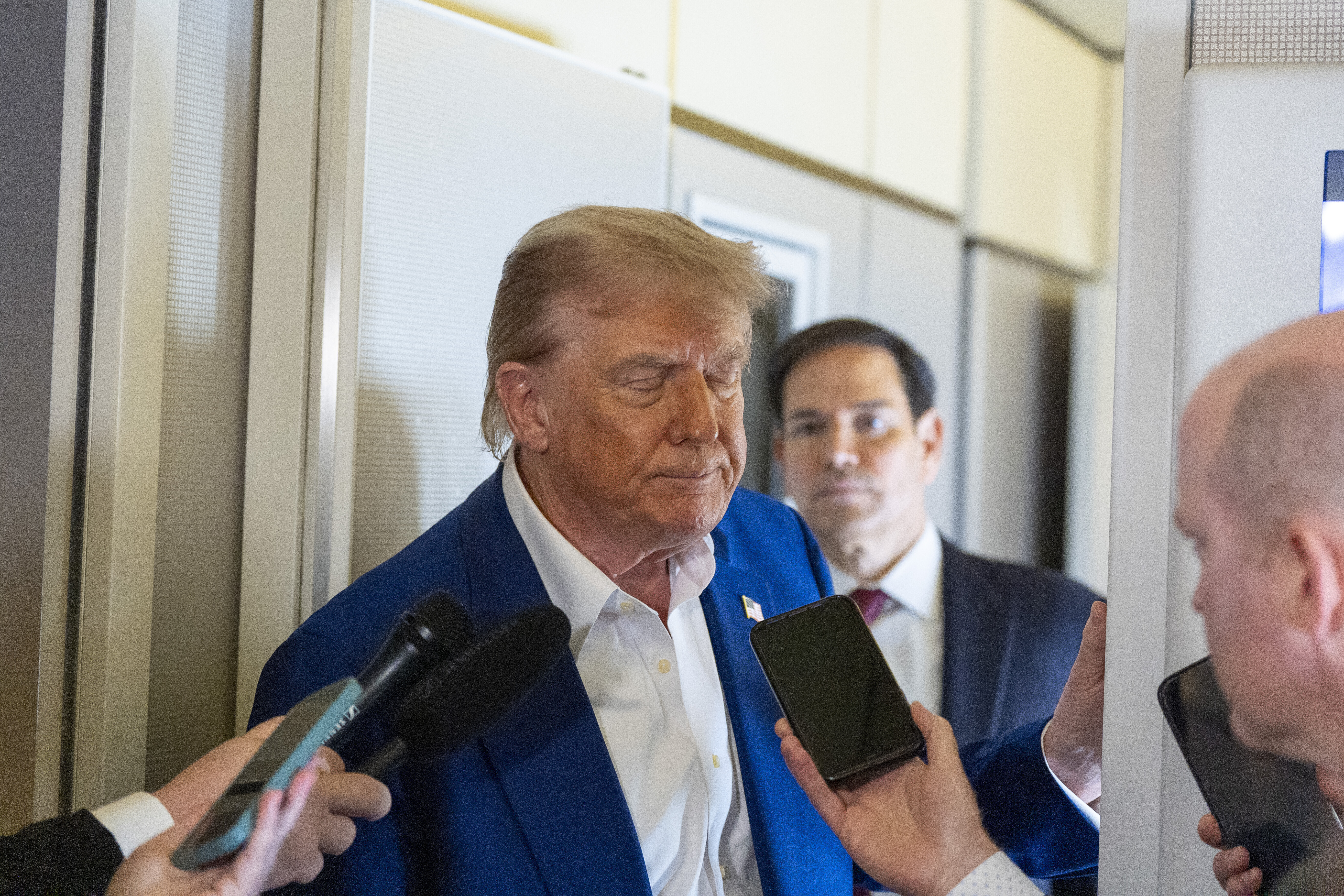 President Donald Trump turns to depart after speaking with reporters on Air Force One while in flight from Joint Base Andrews, Md., to Amsterdam, Netherlands, Tuesday, June 24, 2025. (AP Photo/Alex Brandon)